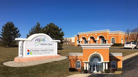 Exterior view of MPI Home Care building with arched brick entrance and sign