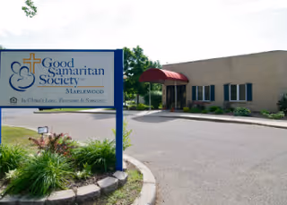 Exterior view of Good Samaritan Society Maplewood with sign and building entrance