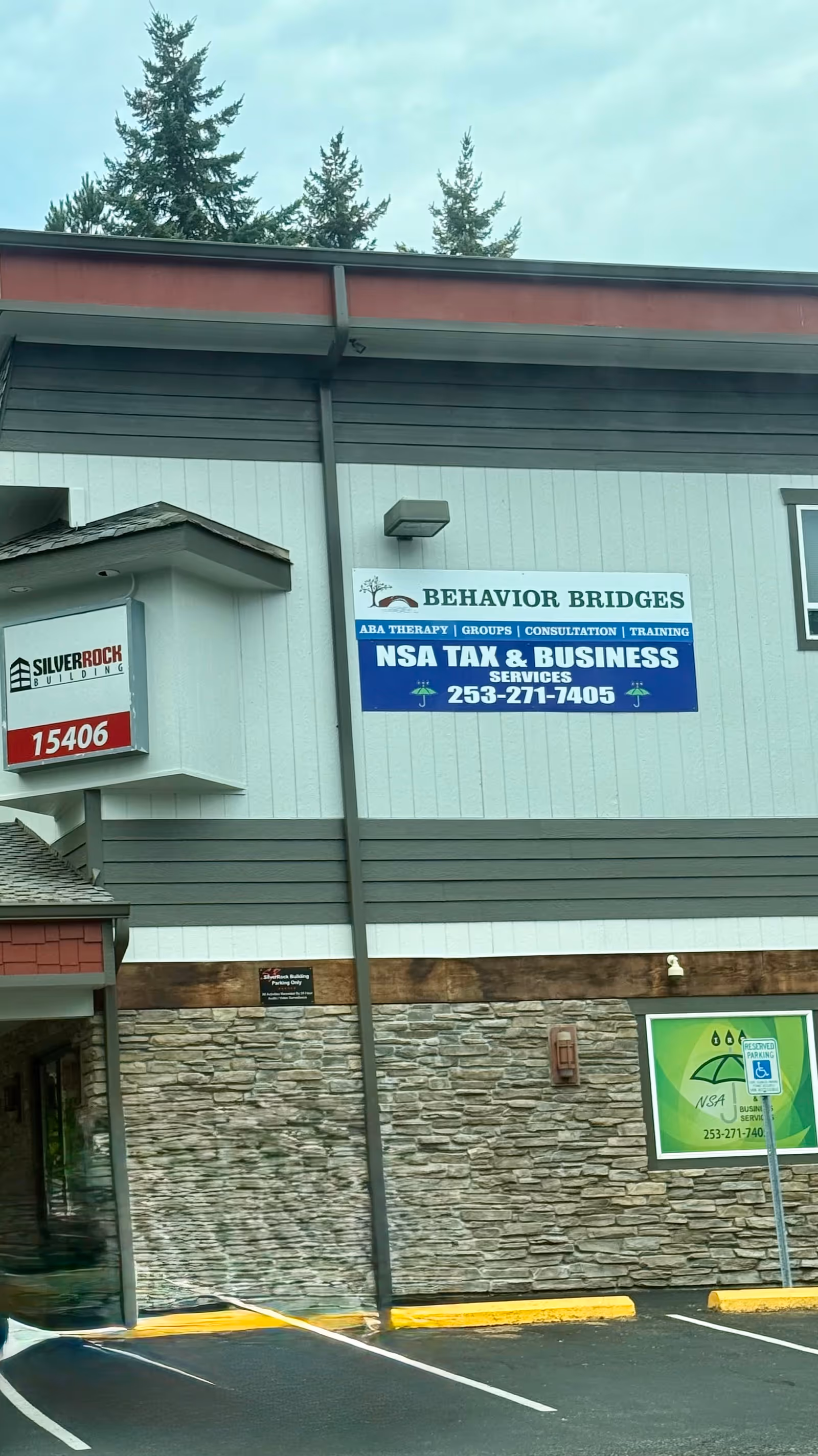 Front exterior of a two-story building with Behavior Bridges sign and NSA Tax & Business Services.
