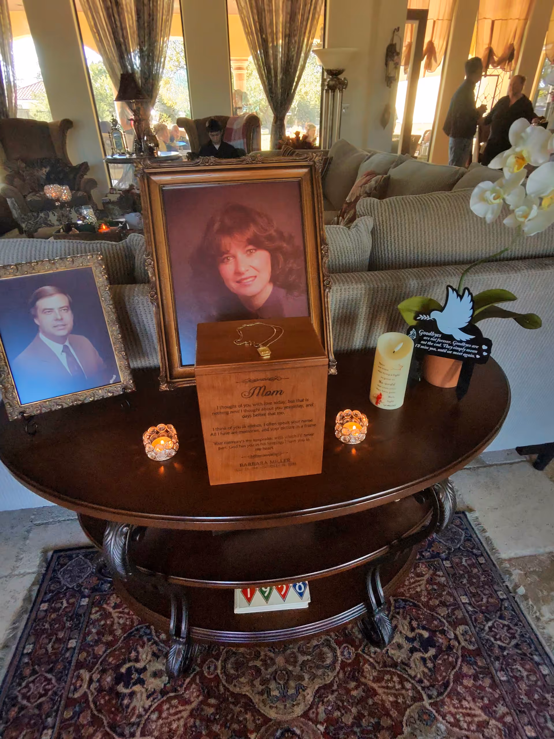Living room in a senior care facility with framed portraits on a round coffee table.