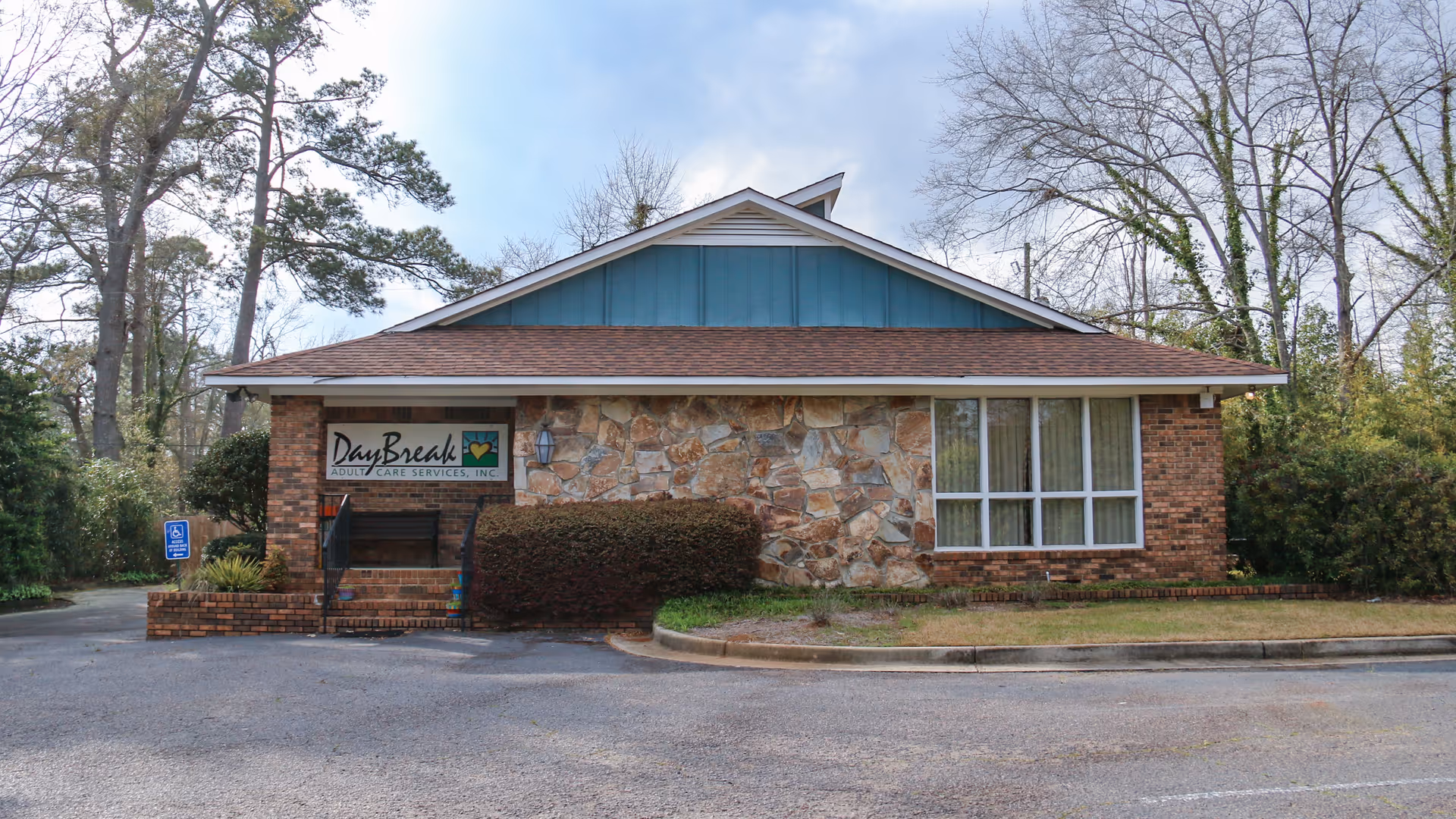 DayBreak Adult Care Services building in Aiken, SC with a stone facade and blue roof.