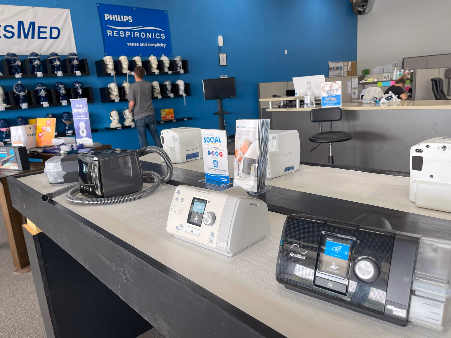 Showroom interior with CPAP machines on a counter and blue wall displays.