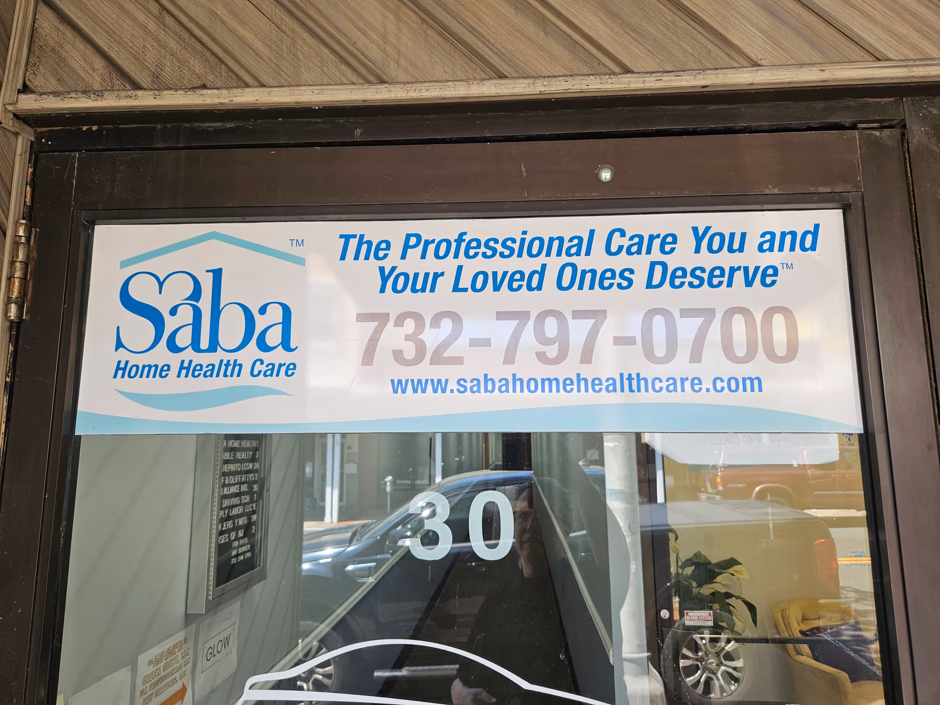 Front entrance with a Saba Home Health Care banner and contact number