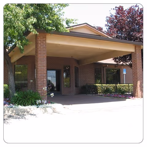Auburn Oaks Care Center exterior entrance with brick facade and a covered porte-cochère.