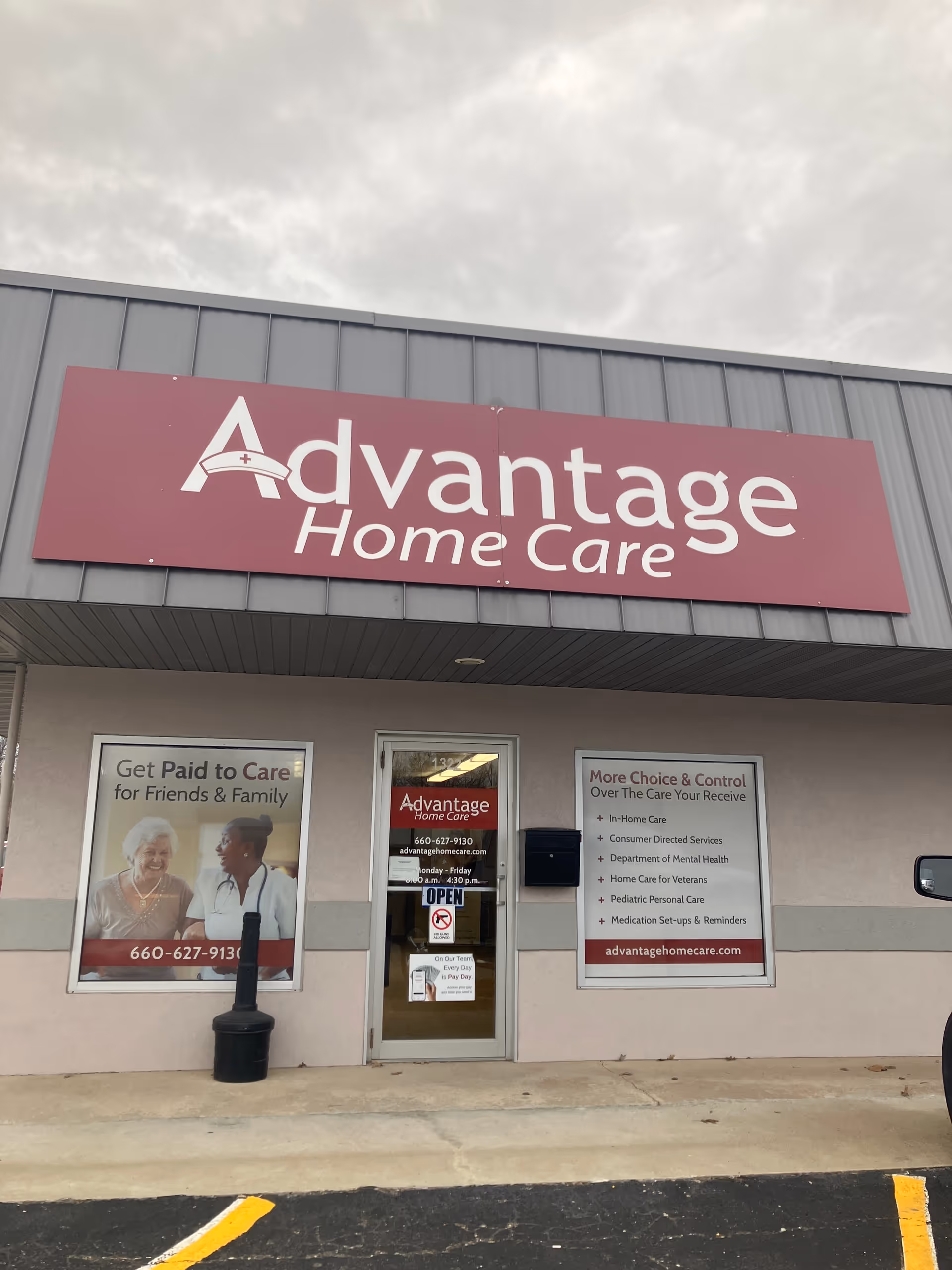 Exterior view of Advantage Home Care storefront with large purple sign and entrance door.