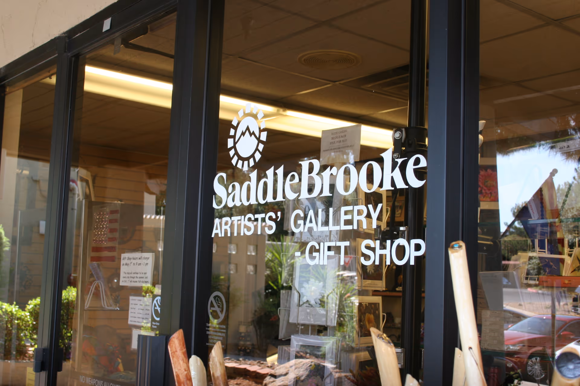 SaddleBrooke storefront with glass doors advertising the Artists' Gallery Gift Shop.