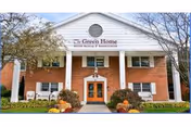 Front view of The Green Home senior living facility with brick exterior.