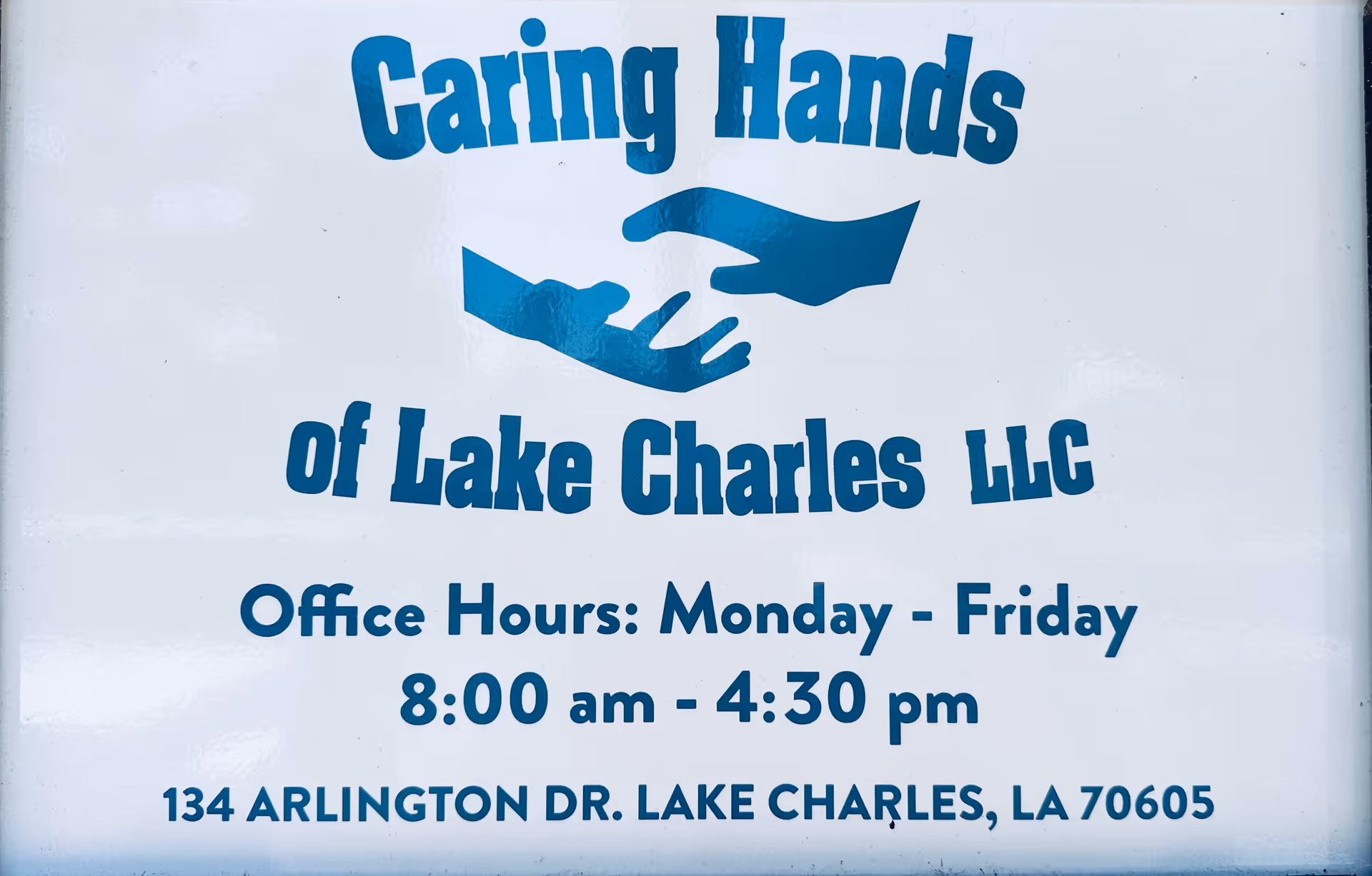 Sign reading Caring Hands of Lake Charles LLC with office hours and address.