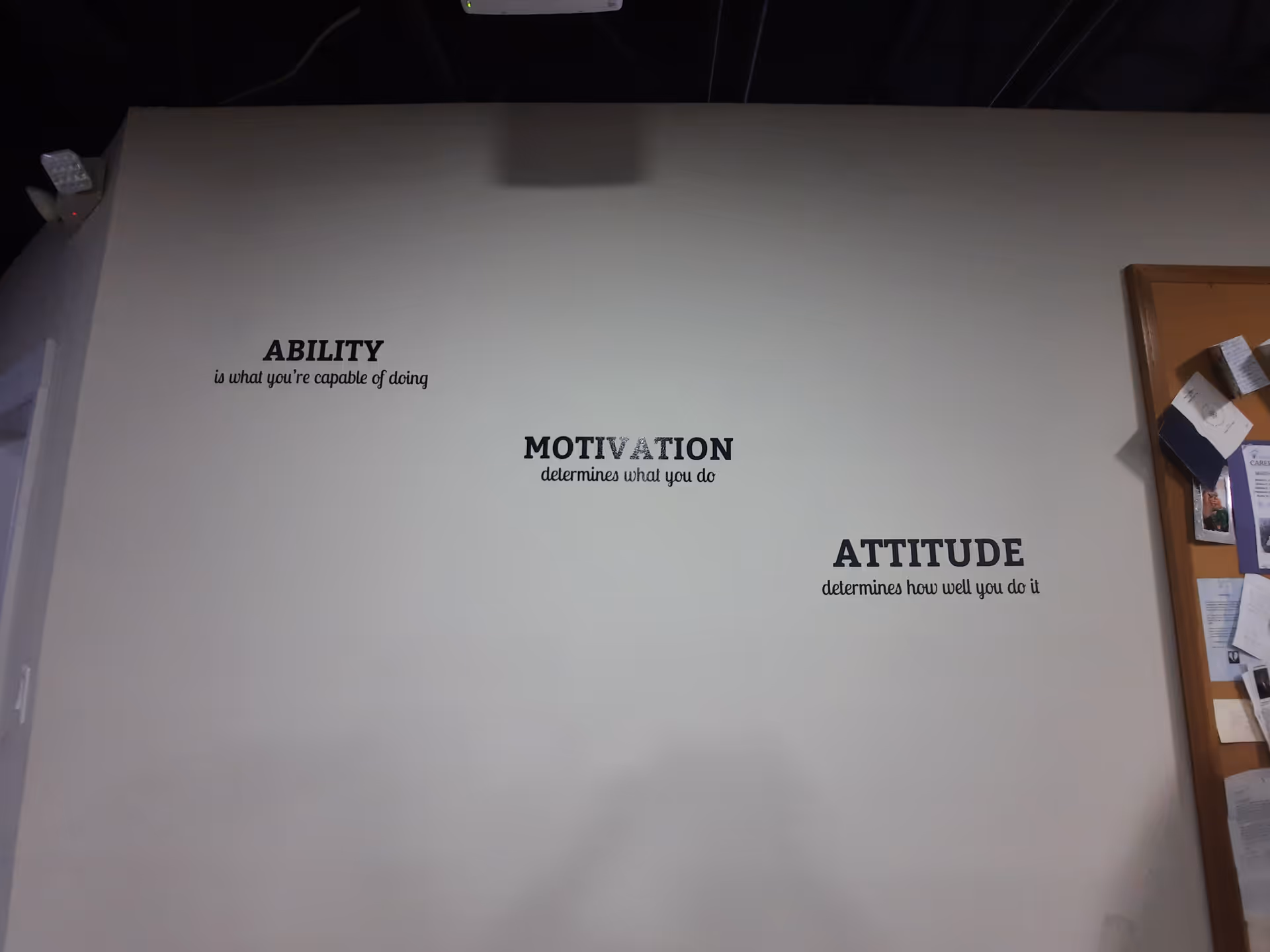 Interior wall in a senior facility with motivational quotes about ability, motivation, and attitude.