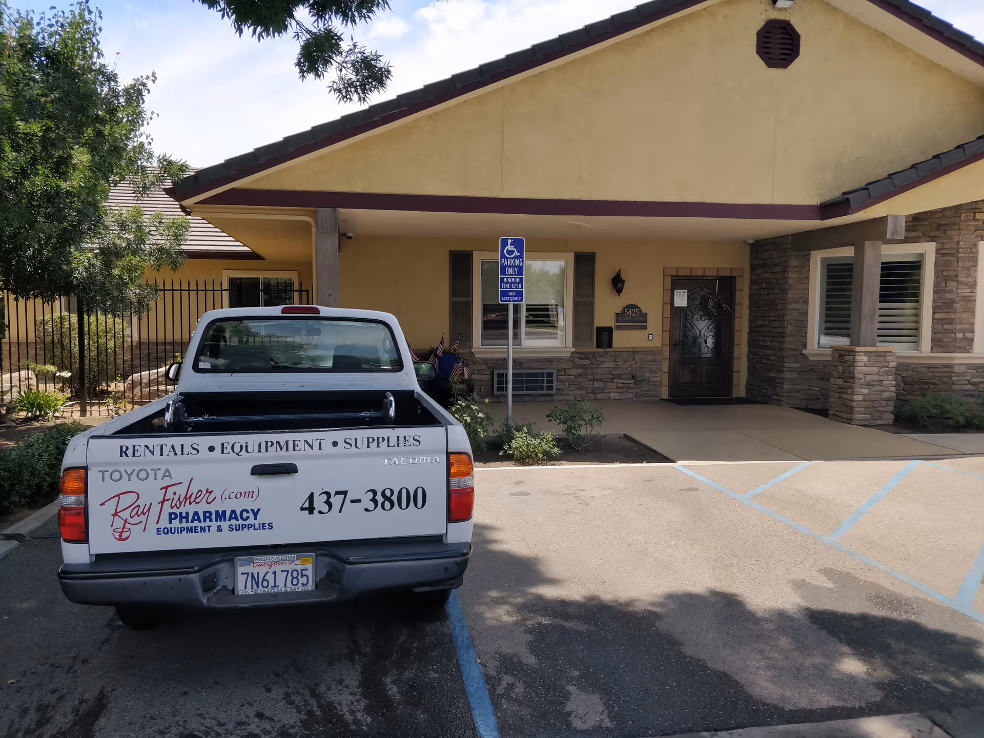 Exterior front of a memory care facility with a parked pickup truck.