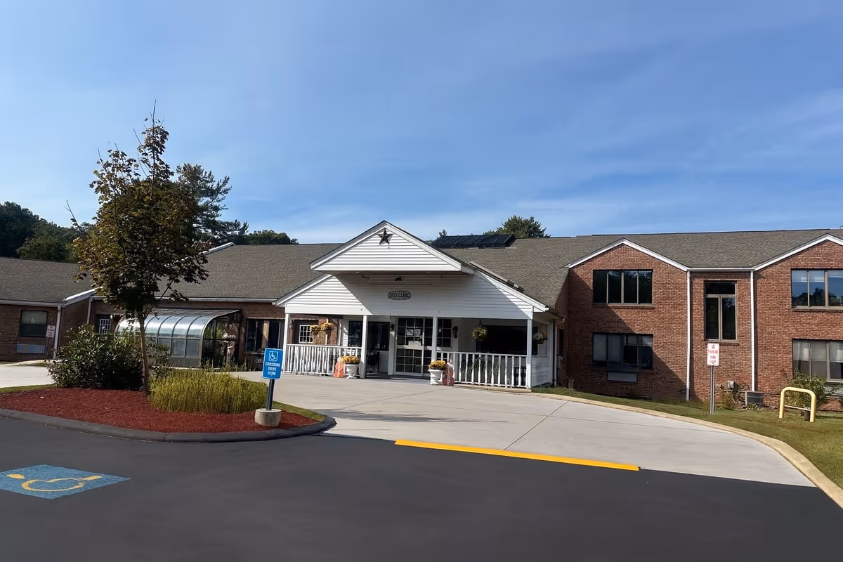 Front view of Hebert Health & Rehabilitation Center with driveway and entrance.