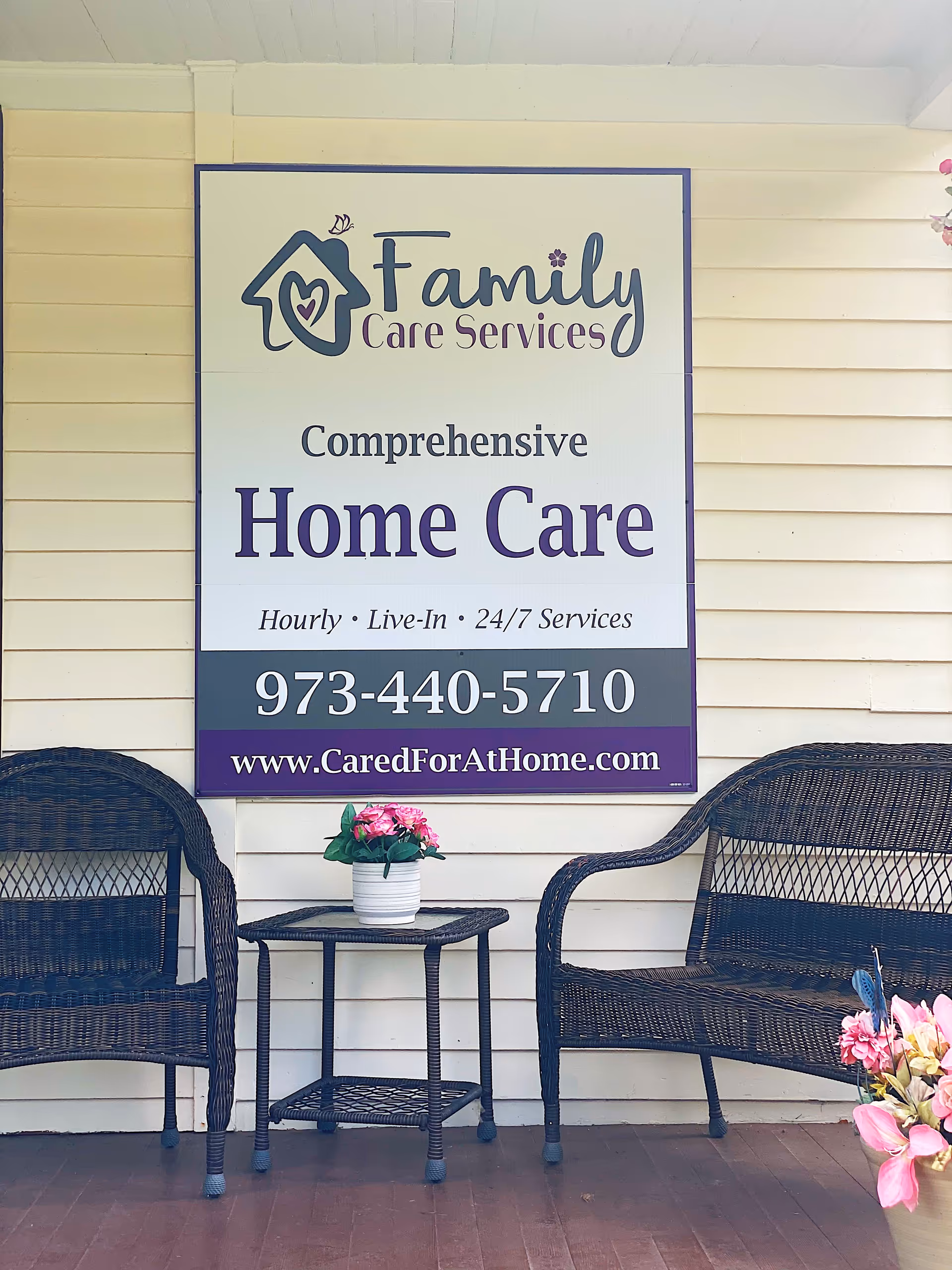 Exterior wall with Family Care Services sign and outdoor wicker seating with a table.