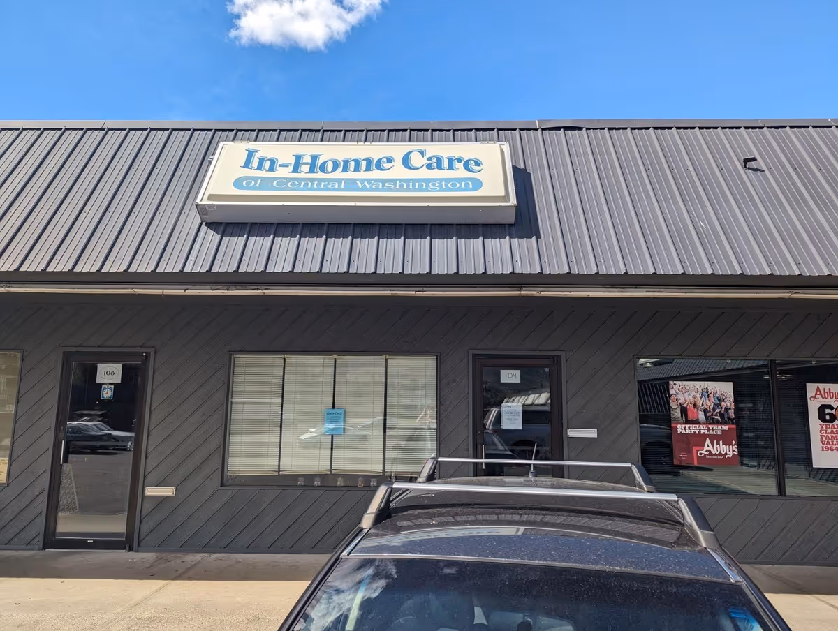 Front view of a gray commercial building with an In-Home Care sign.