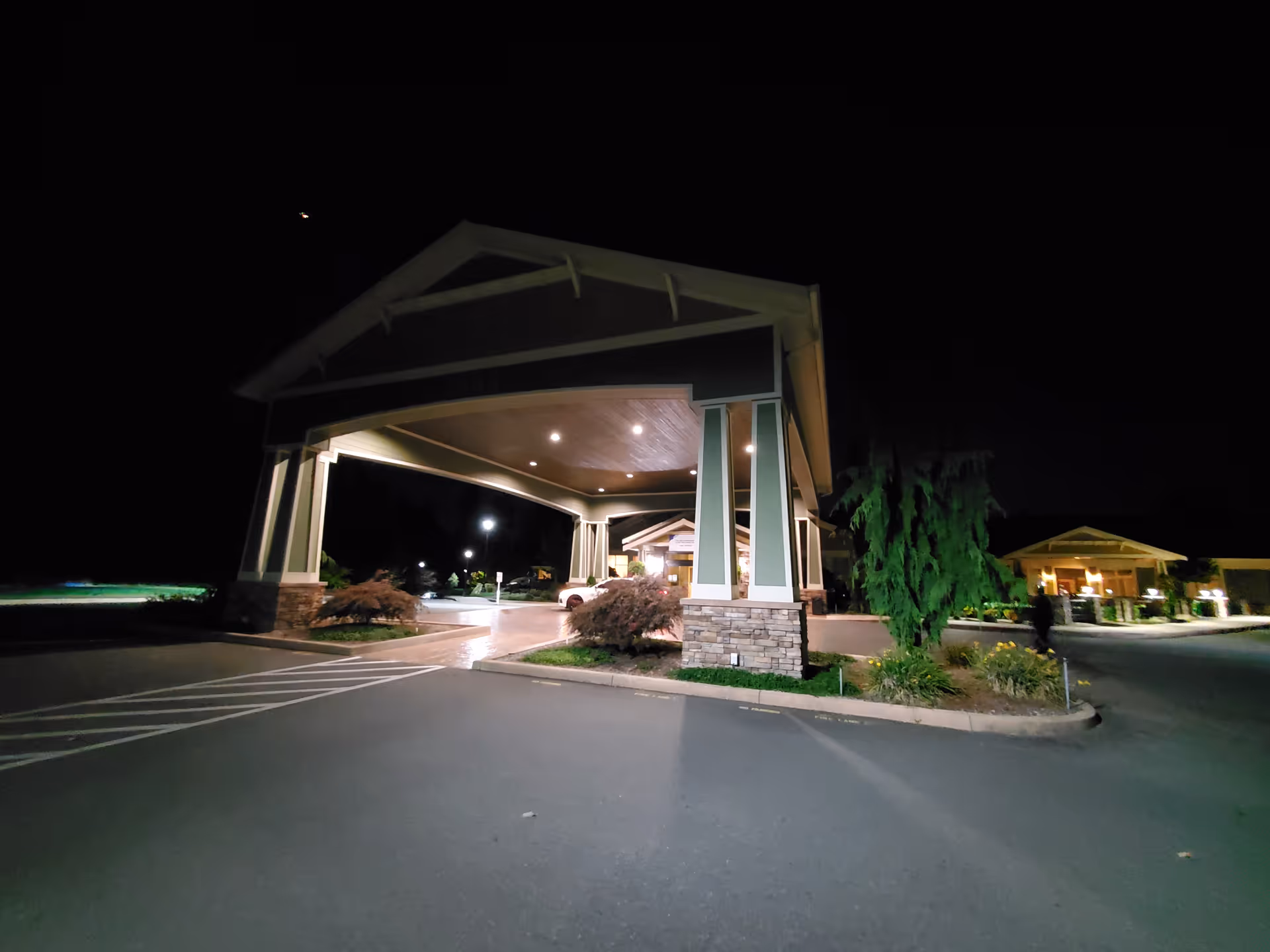 Nighttime exterior view of Life Care Center of South Hill entrance with porte-cochere.