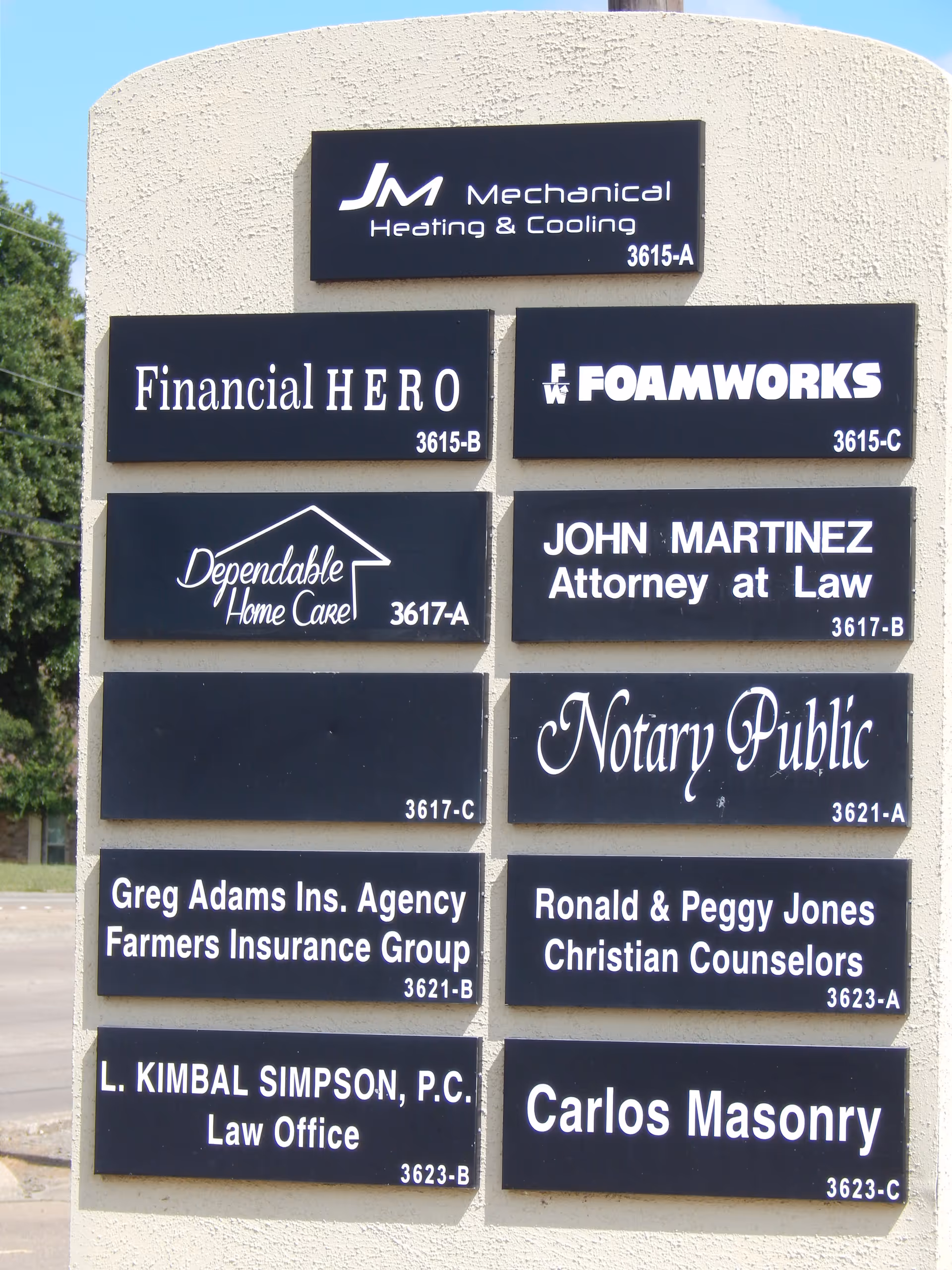 Beige building exterior with a sign column displaying multiple business names including Dependable Home Care.