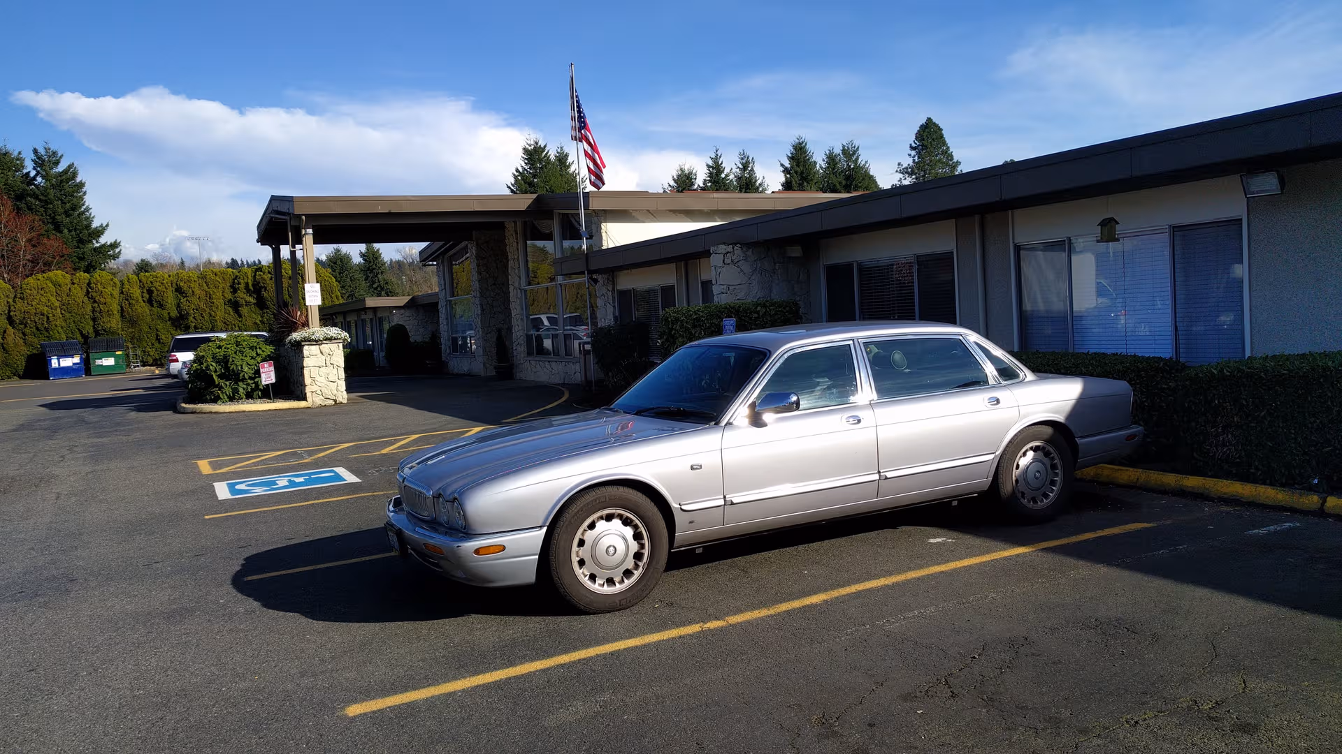 Silver sedan parked in front of North Auburn Rehab & Health, a single-story facility.