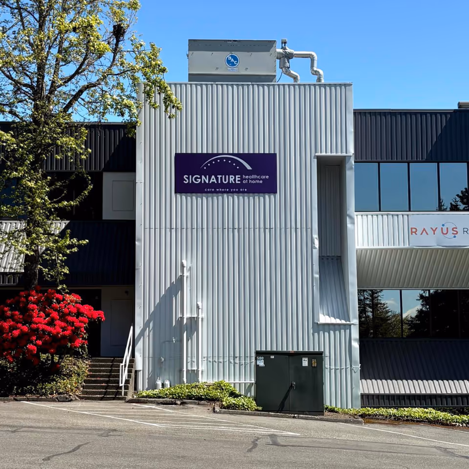 Exterior view of Signature Healthcare at Home building with signage on a metal facade