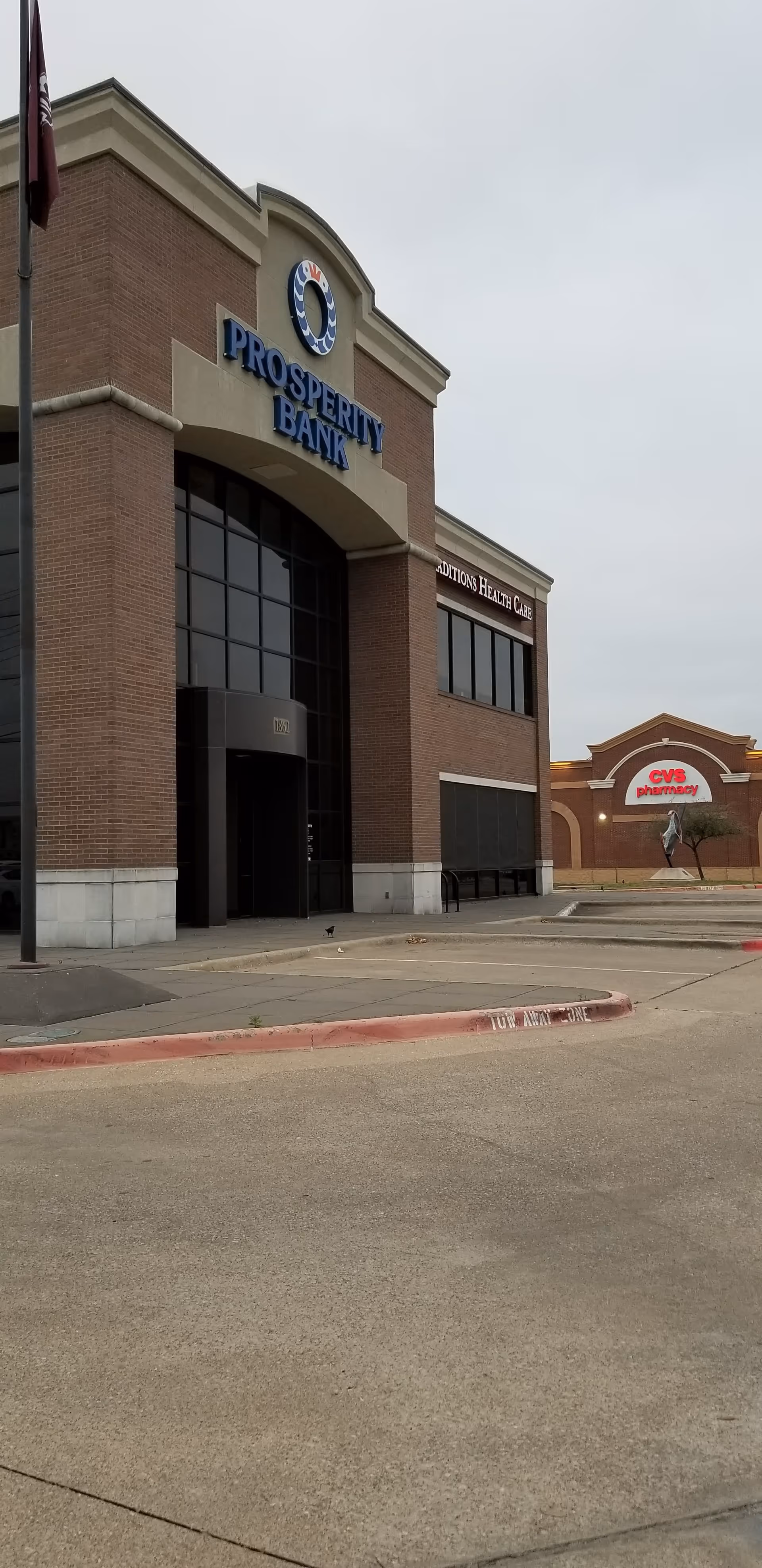 Exterior view of a brick bank building with Prosperity Bank signage and a CVS nearby.