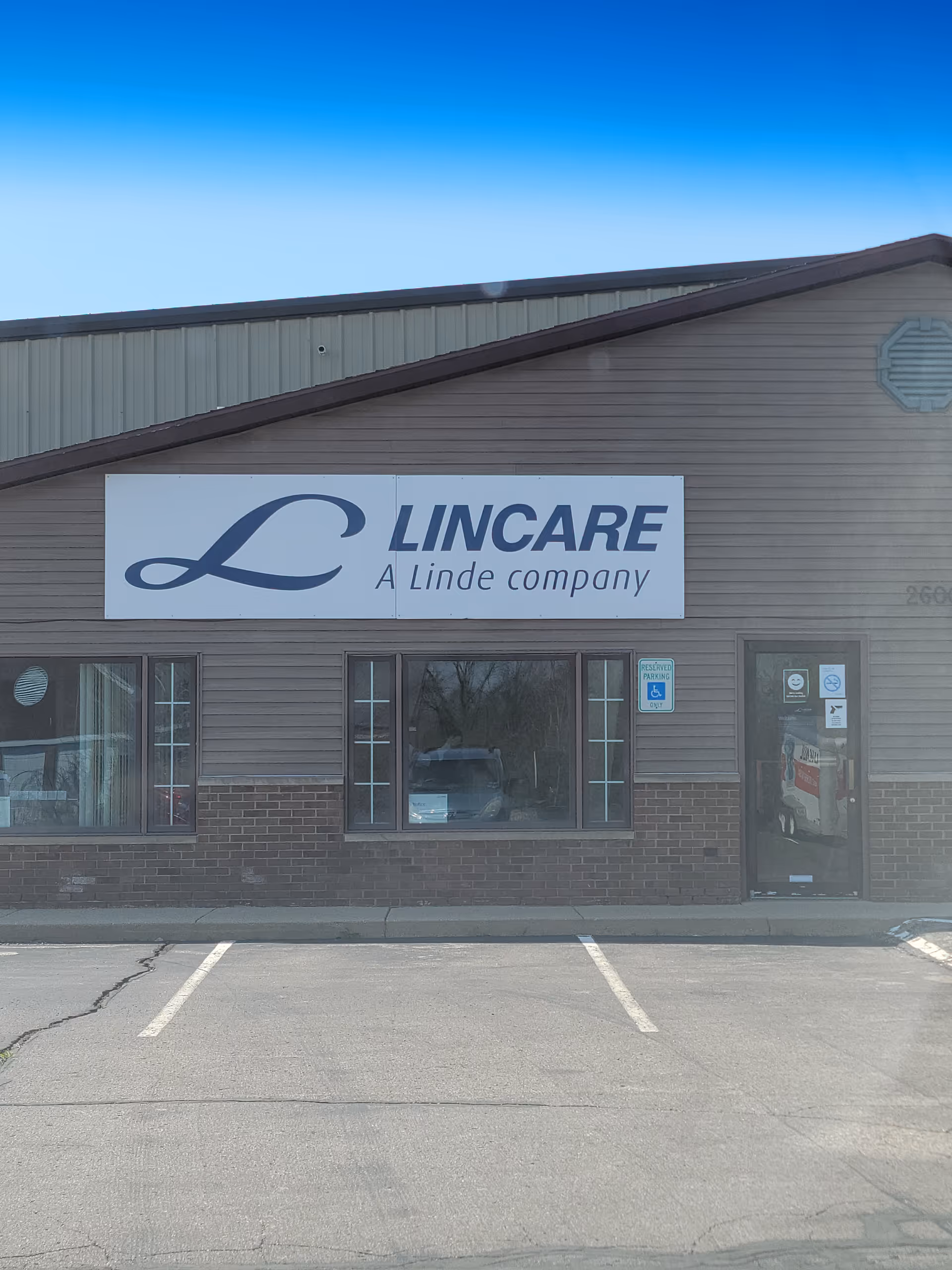 Front view of LINCARE storefront with sign and parking lot.