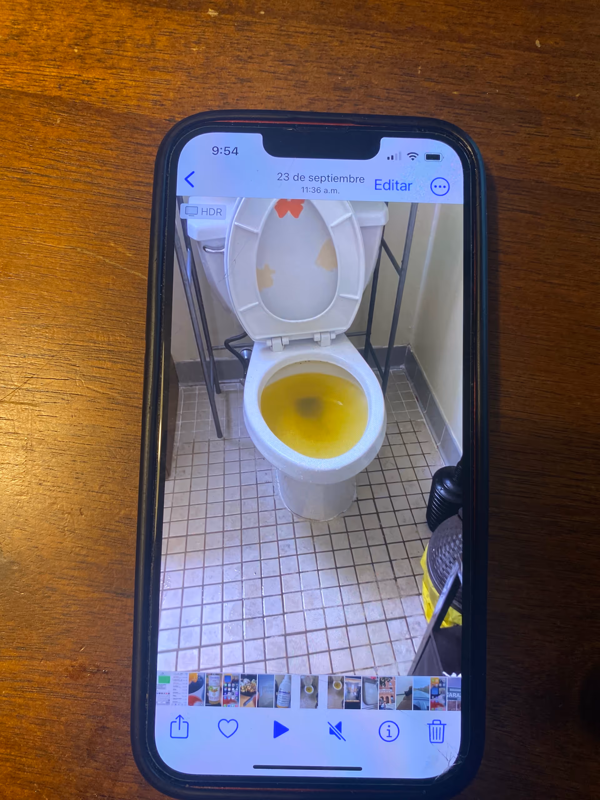 Toilet with yellow staining inside a tiled bathroom.