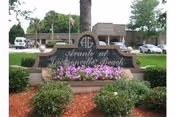 Exterior view of Avante Villa at Jacksonville Beach with landscaped entrance sign.
