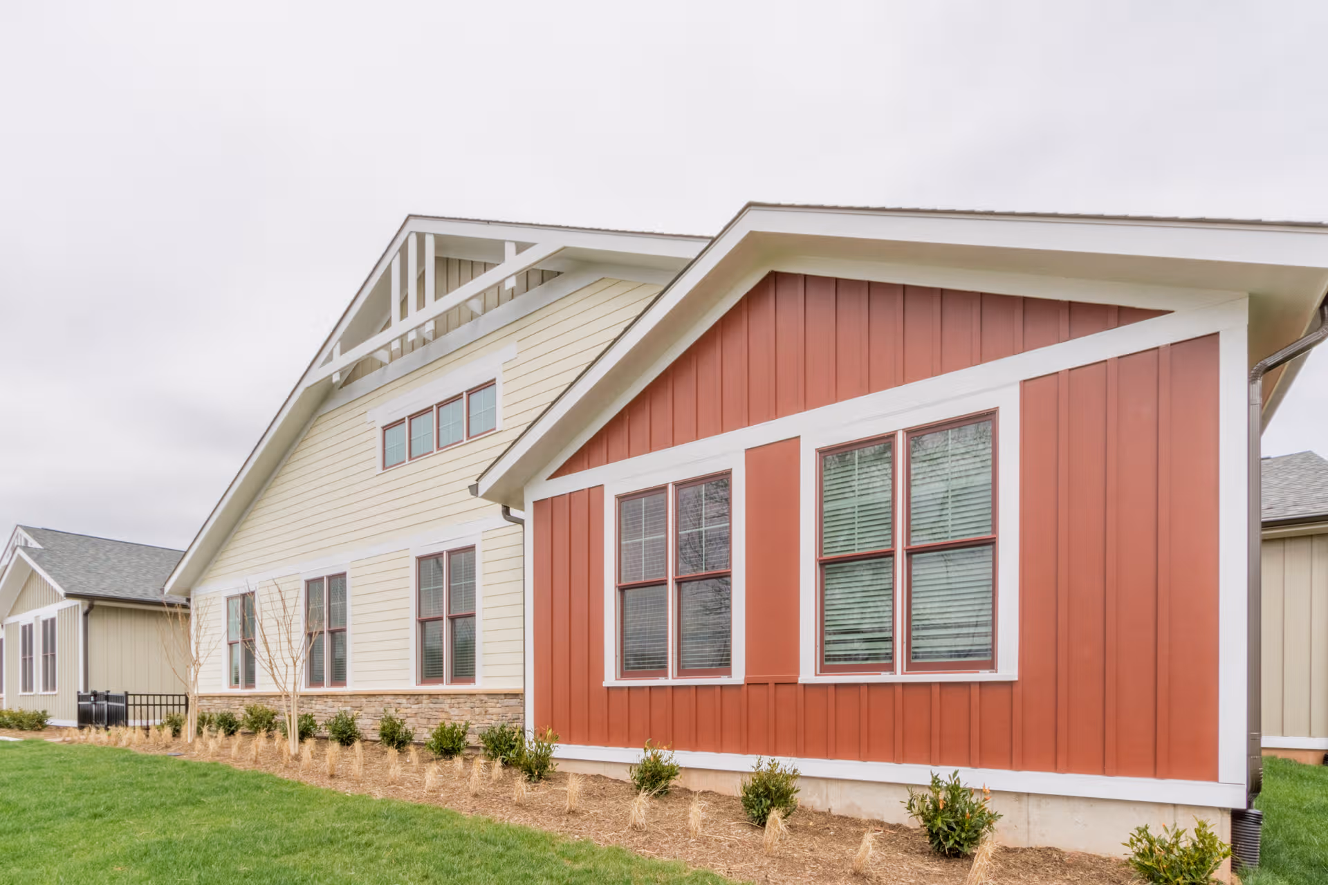 Chantilly Heights Memory Care exterior with beige and red siding and green lawn.
