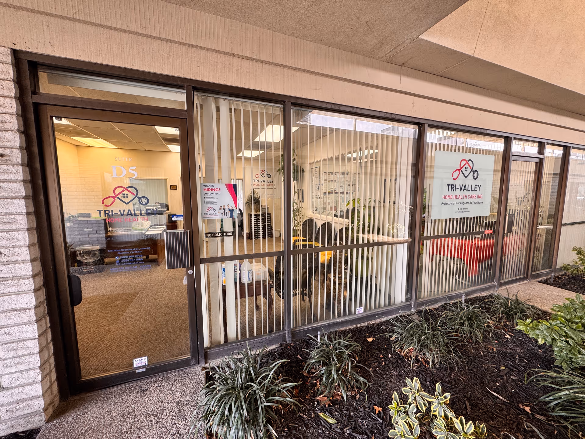 Front entrance of Tri-Valley Home Health Care Inc. with glass doors and signage.