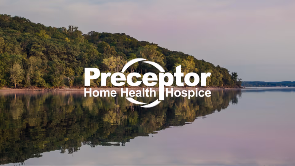 Lakeside landscape with trees reflecting on water and a Preceptor logo.