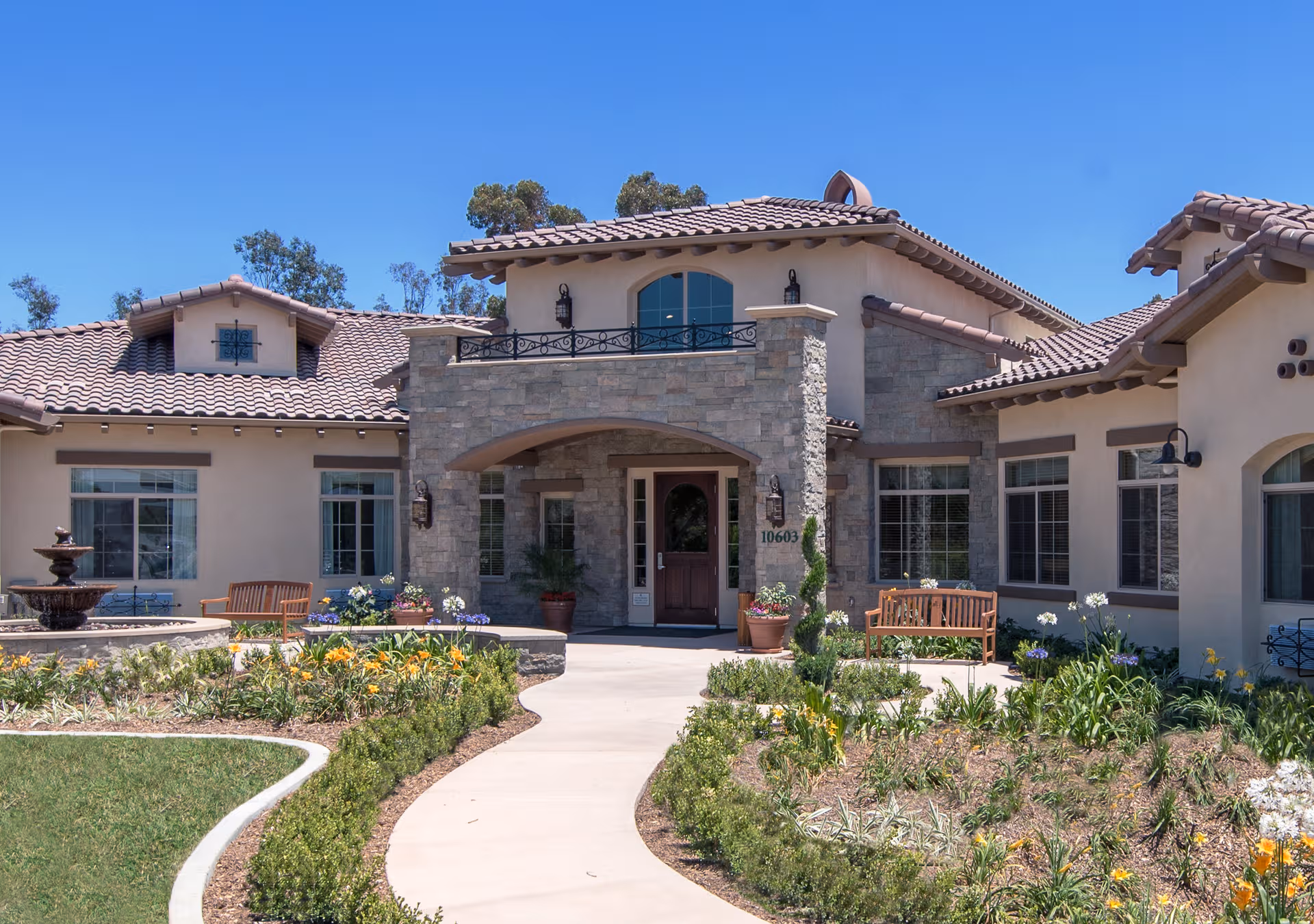 Front exterior view of ActivCare 4S Ranch facility with stone entrance and landscaped courtyard.