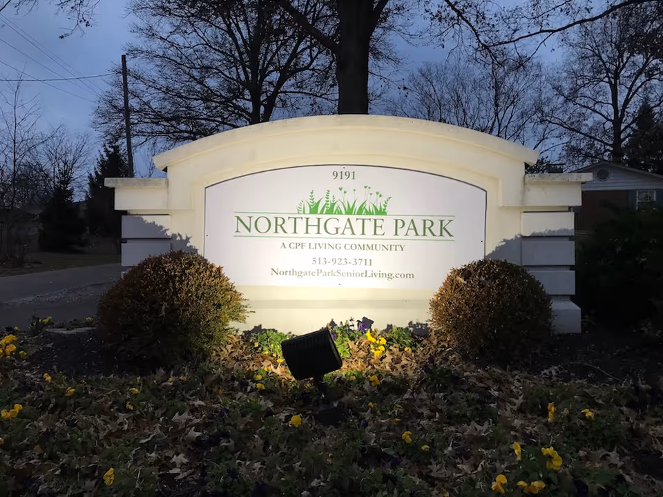 Entrance sign for Northgate Park with landscaping and trees in background.
