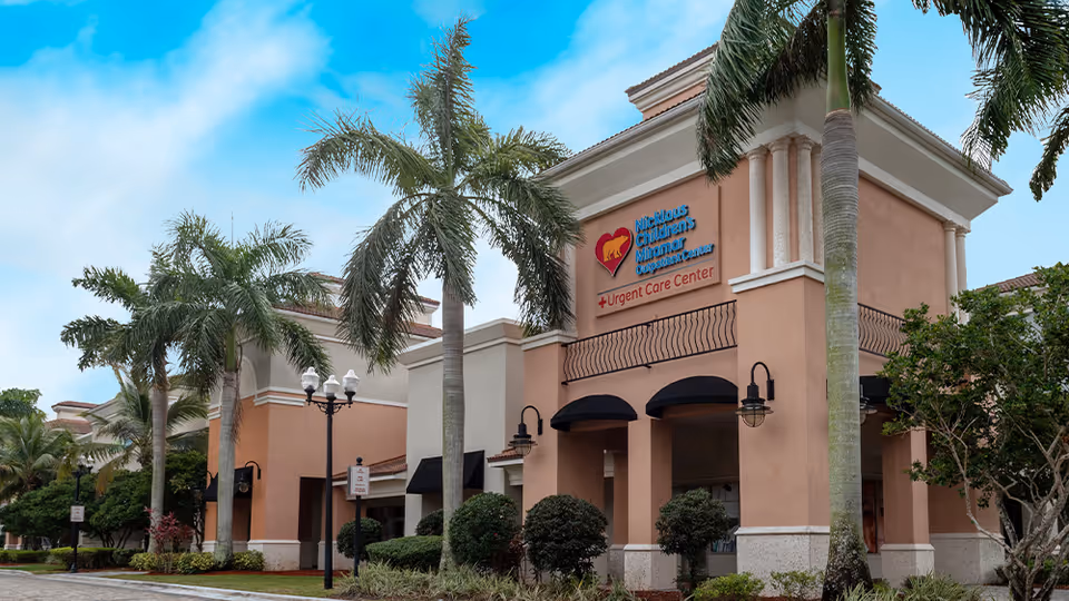Exterior view of Nicklaus Children's Miramar Outpatient Center with palm trees.