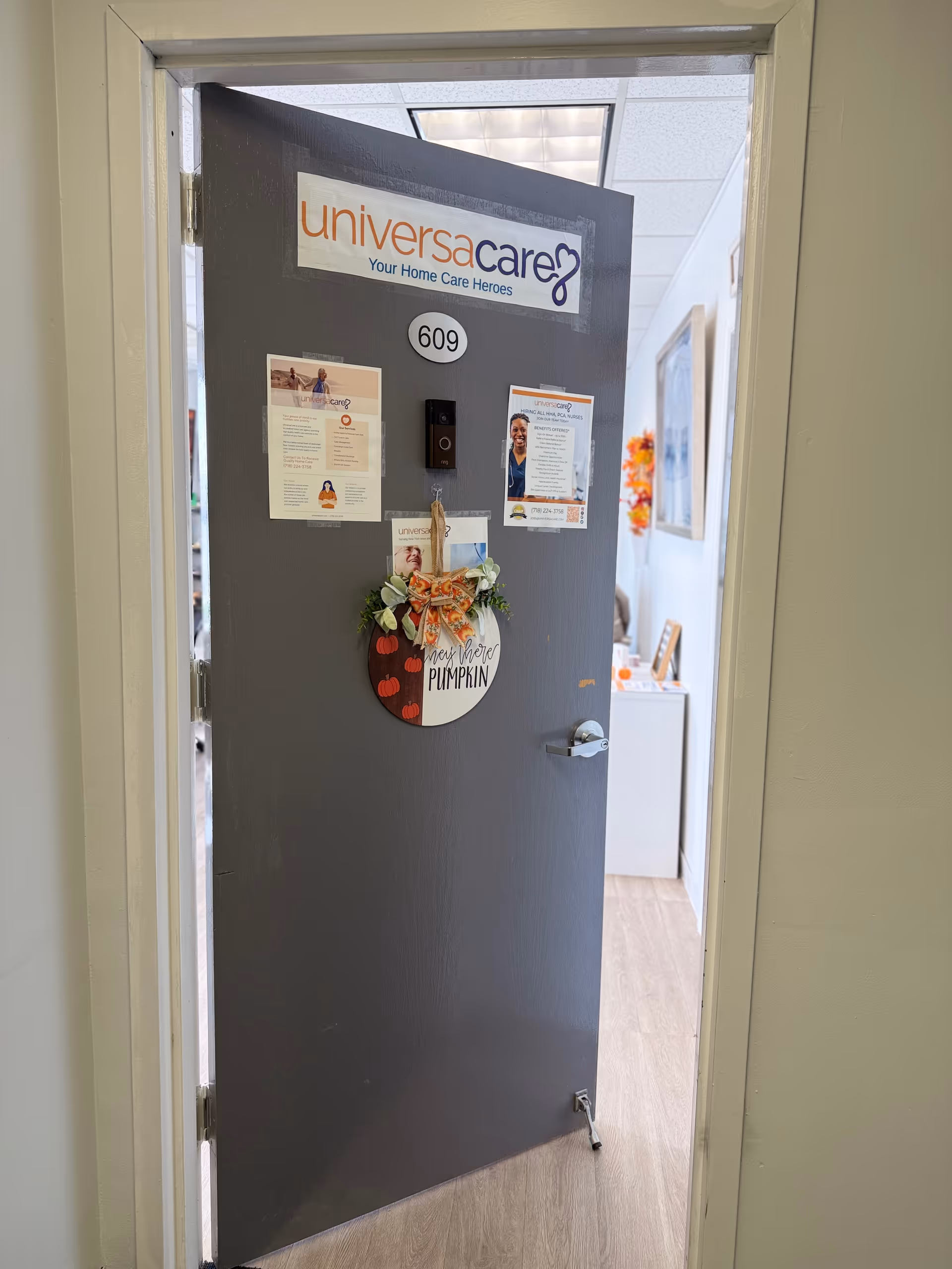 Open doorway shows a UniversaCare door with room number 609 and notices.