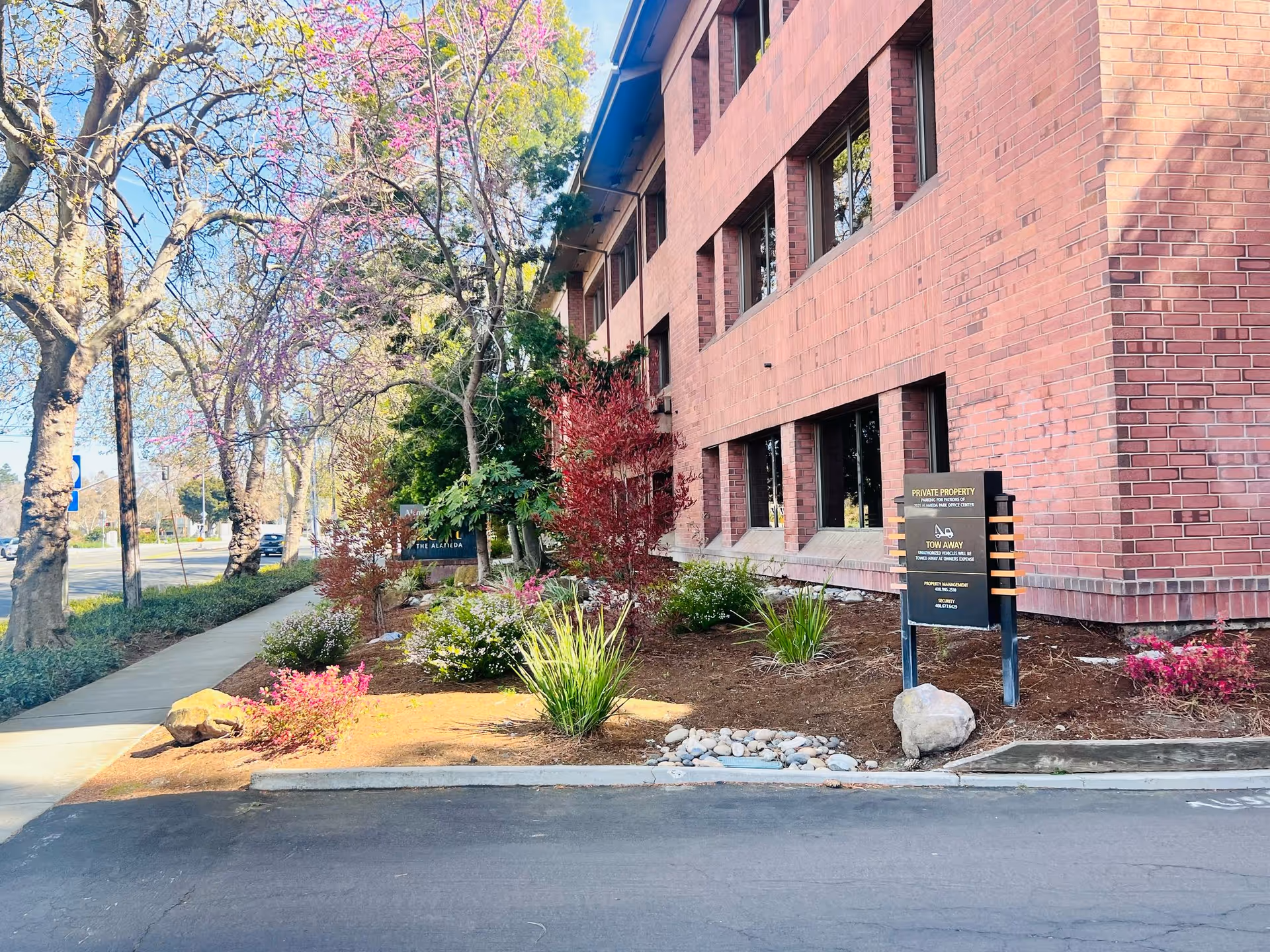 Brick exterior of SZM DIGNITY HOMECARE with landscaped front yard and sidewalk.