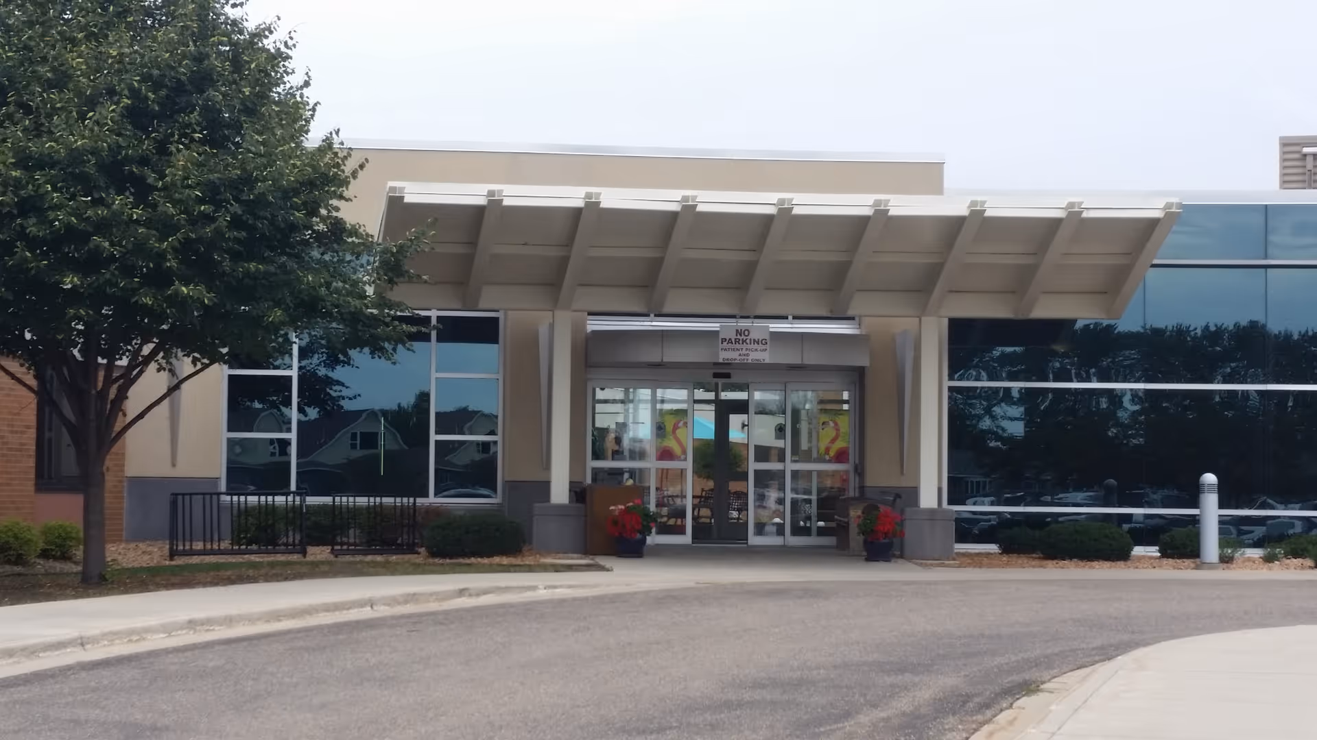 CentraCare Sauk Centre Nursing Home entrance with glass doors under a white canopy.