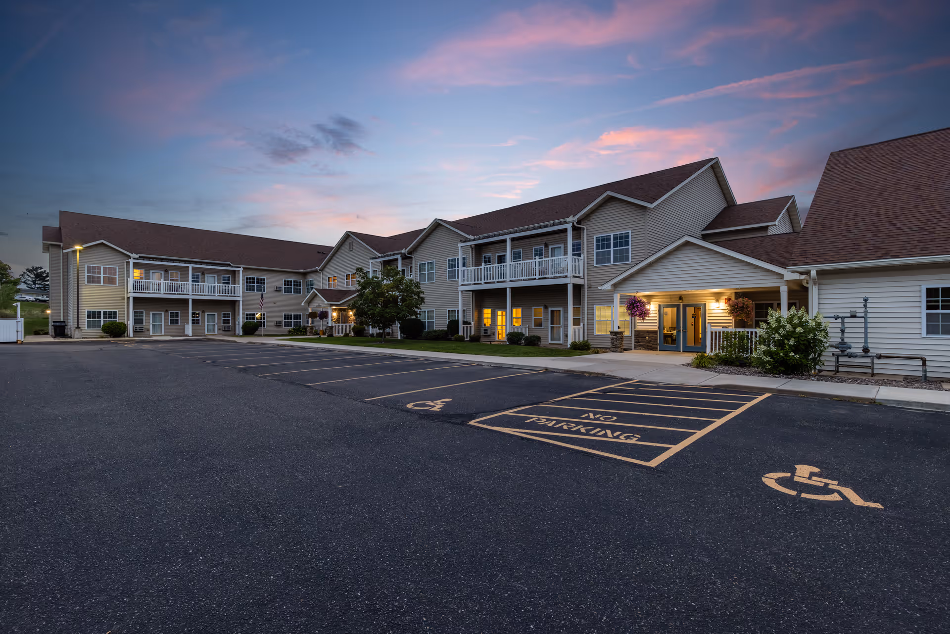 Exterior view of Milestone Senior Living Eau Claire buildings with a parking lot.