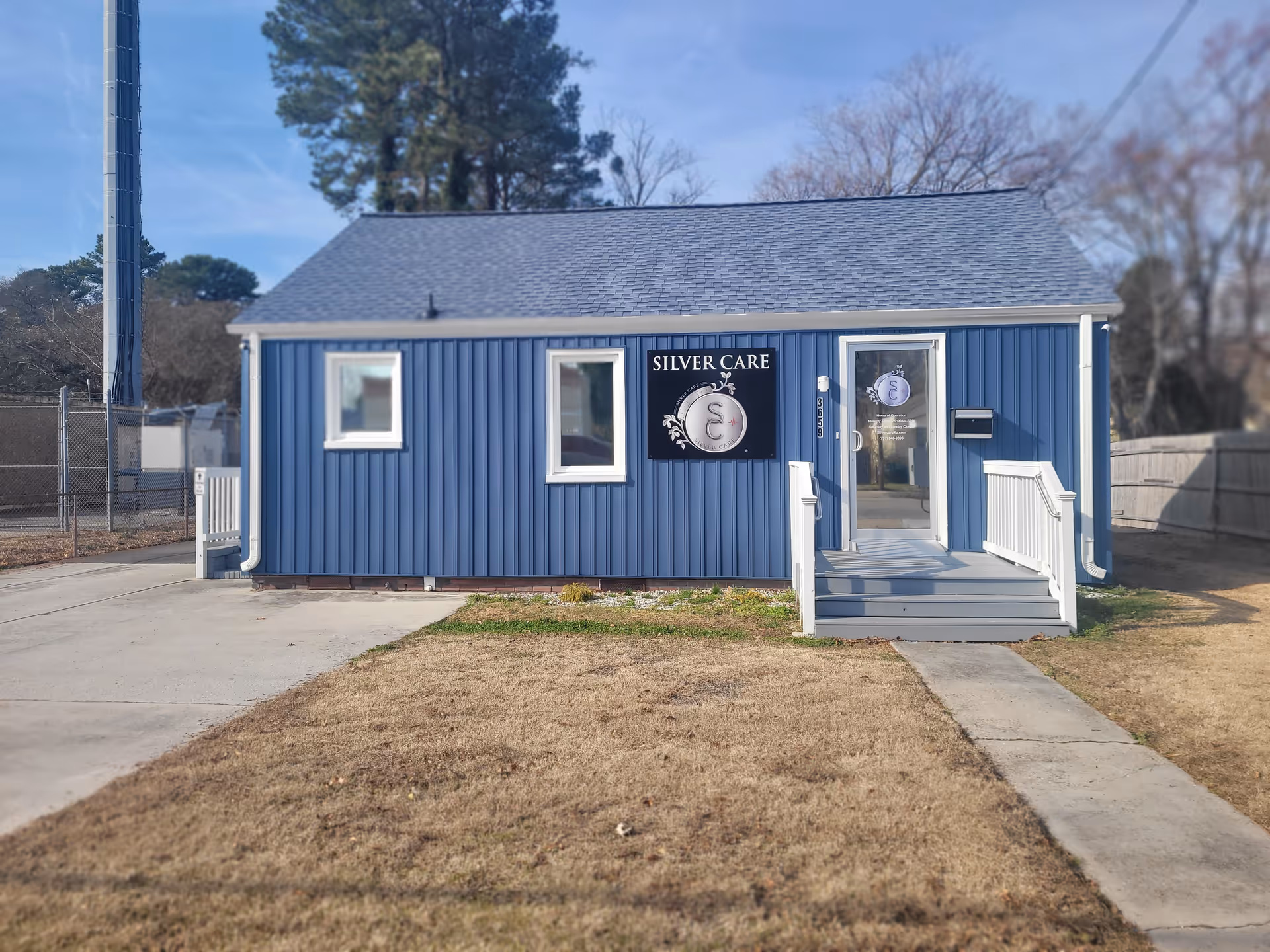 Blue metal building labeled Silver Care with steps and glass entrance.