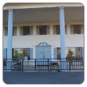 Front exterior of Westview Healthcare Center with blue doors, tall columns, and railing.