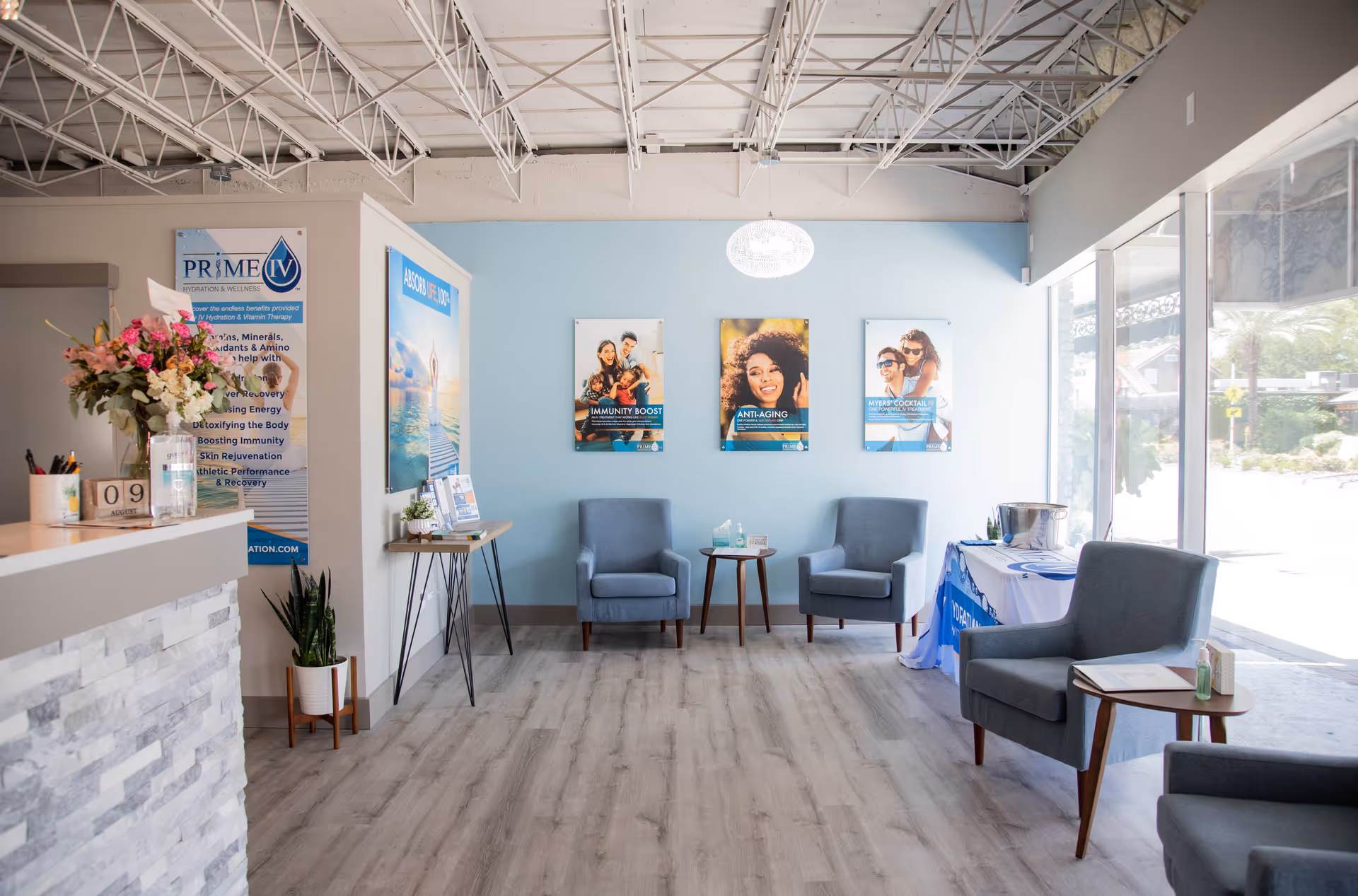 Prime IV Wellness reception area with blue chairs and posters.