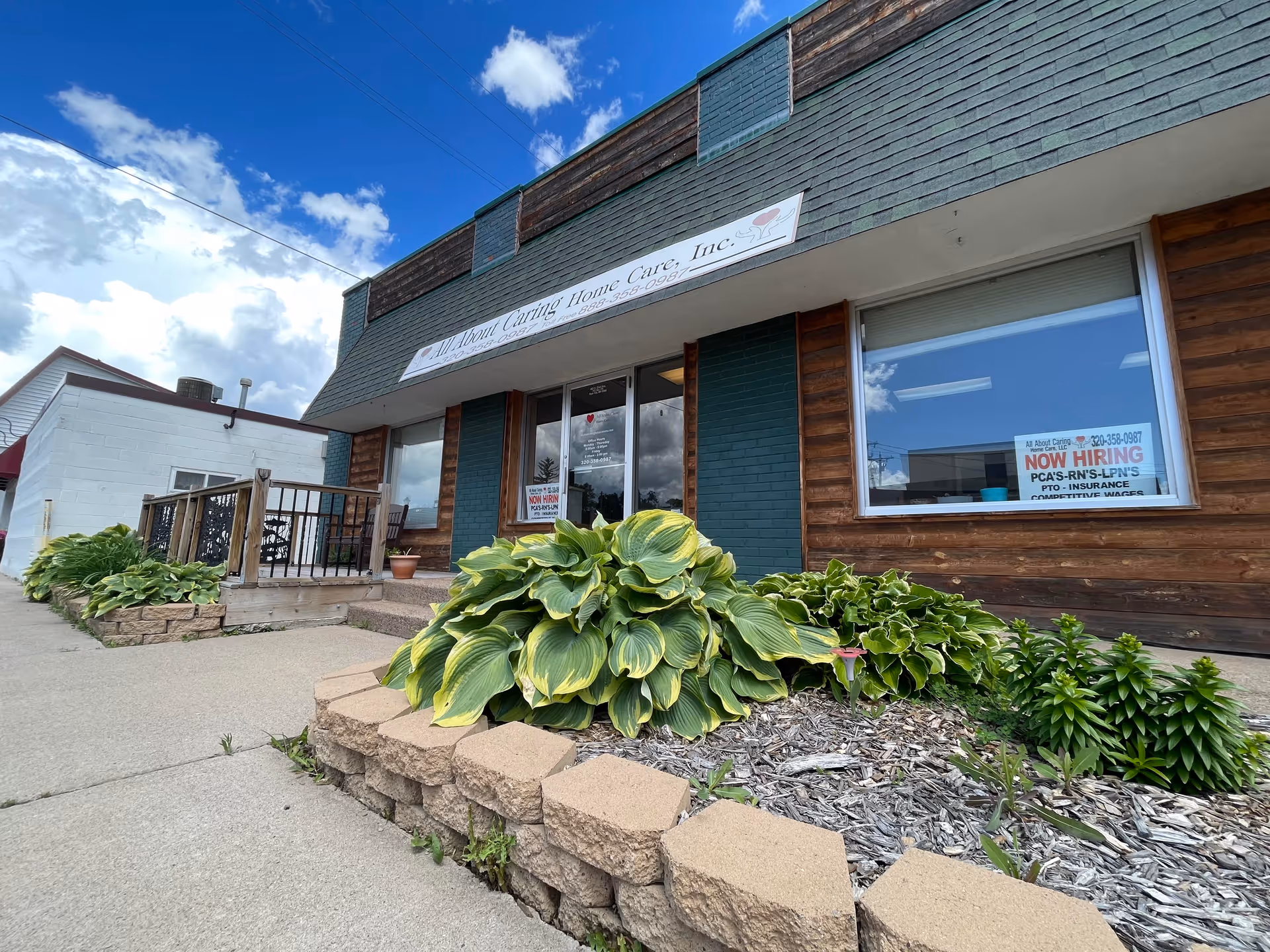 Exterior of All About Caring Home Care building with storefront window and landscaped front yard.