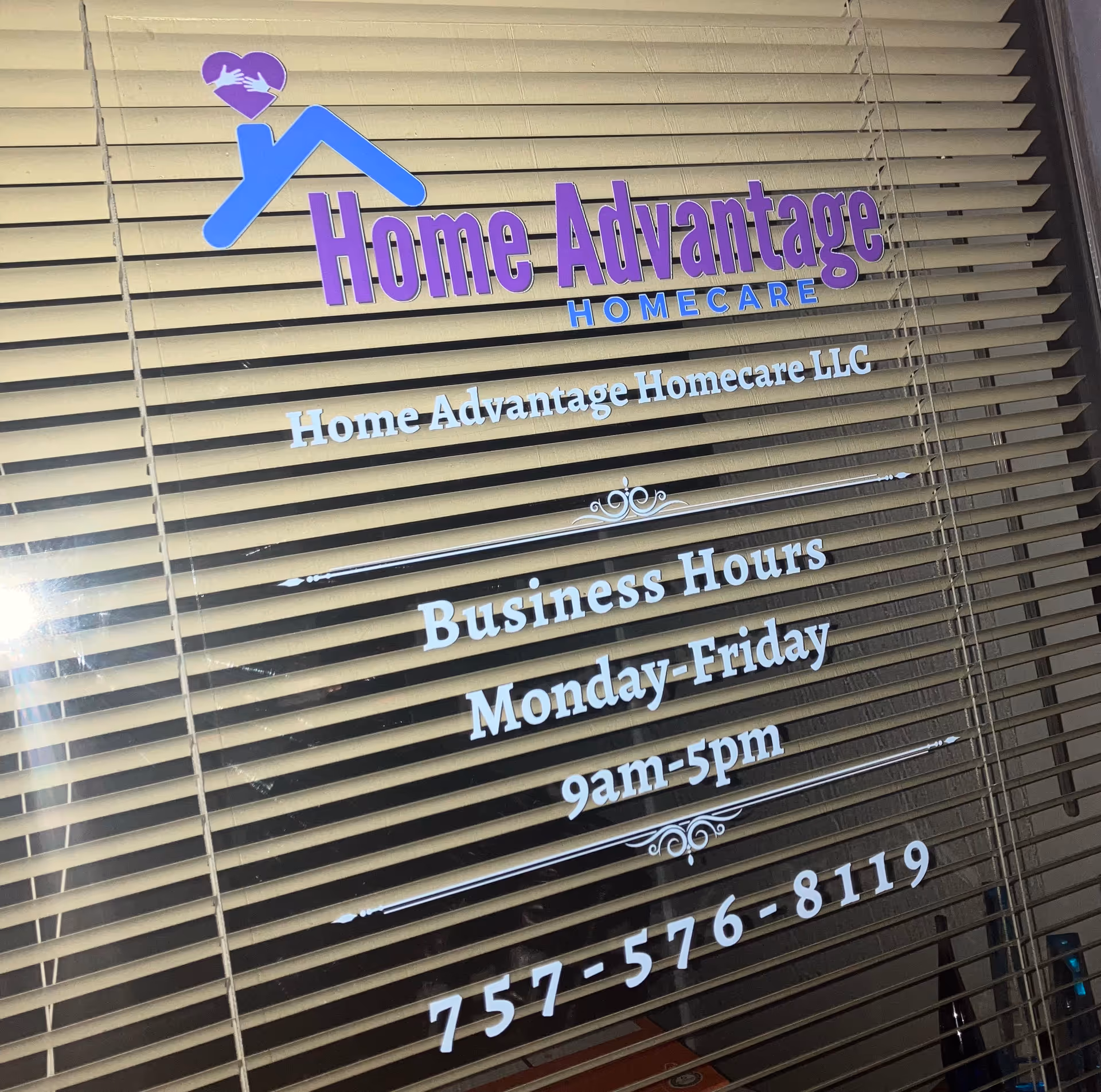 Window blinds display a Home Advantage Homecare sign with business hours.