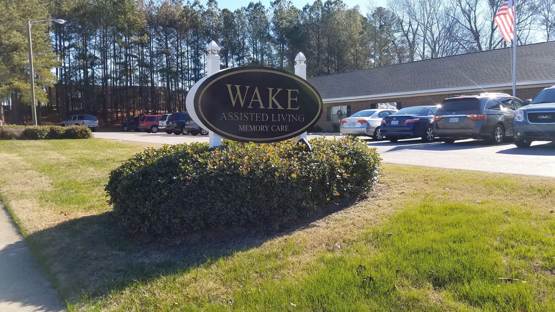 Wake Assisted Living Memory Care sign in front of the building with cars
