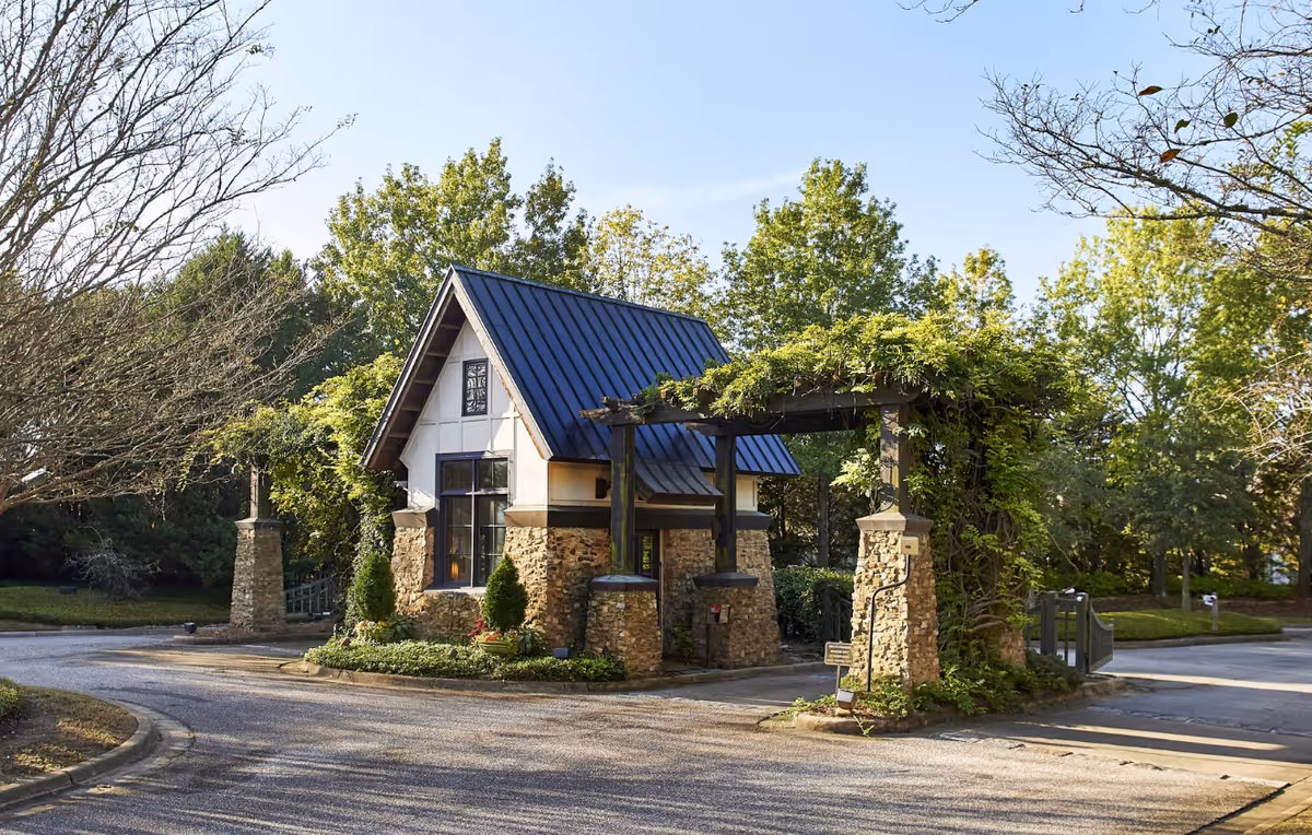 Front view of Oak Grove Inn entrance with stone pillars and blue metal roof