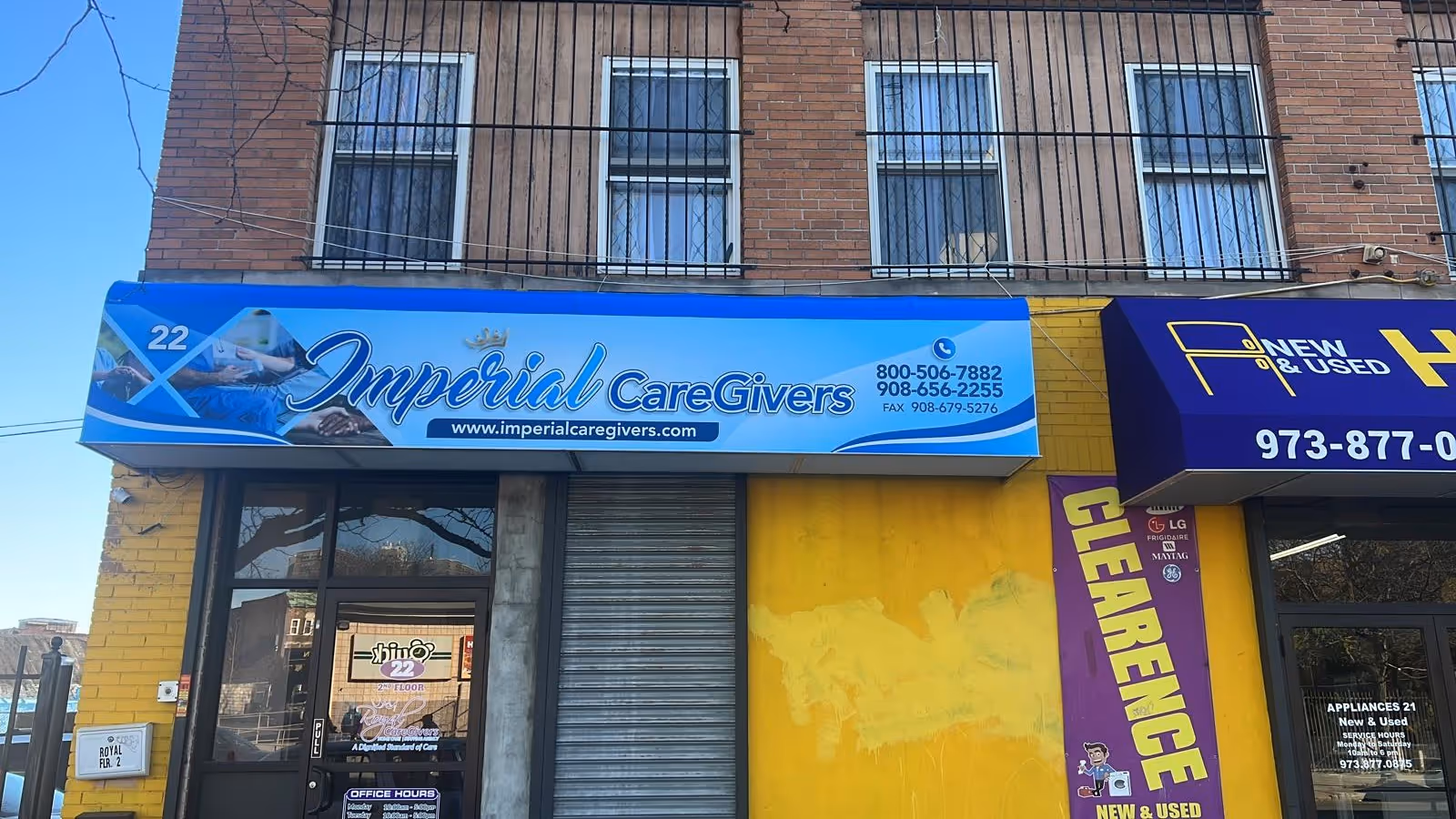 Blue Imperial CareGivers storefront sign on brick building with glass door