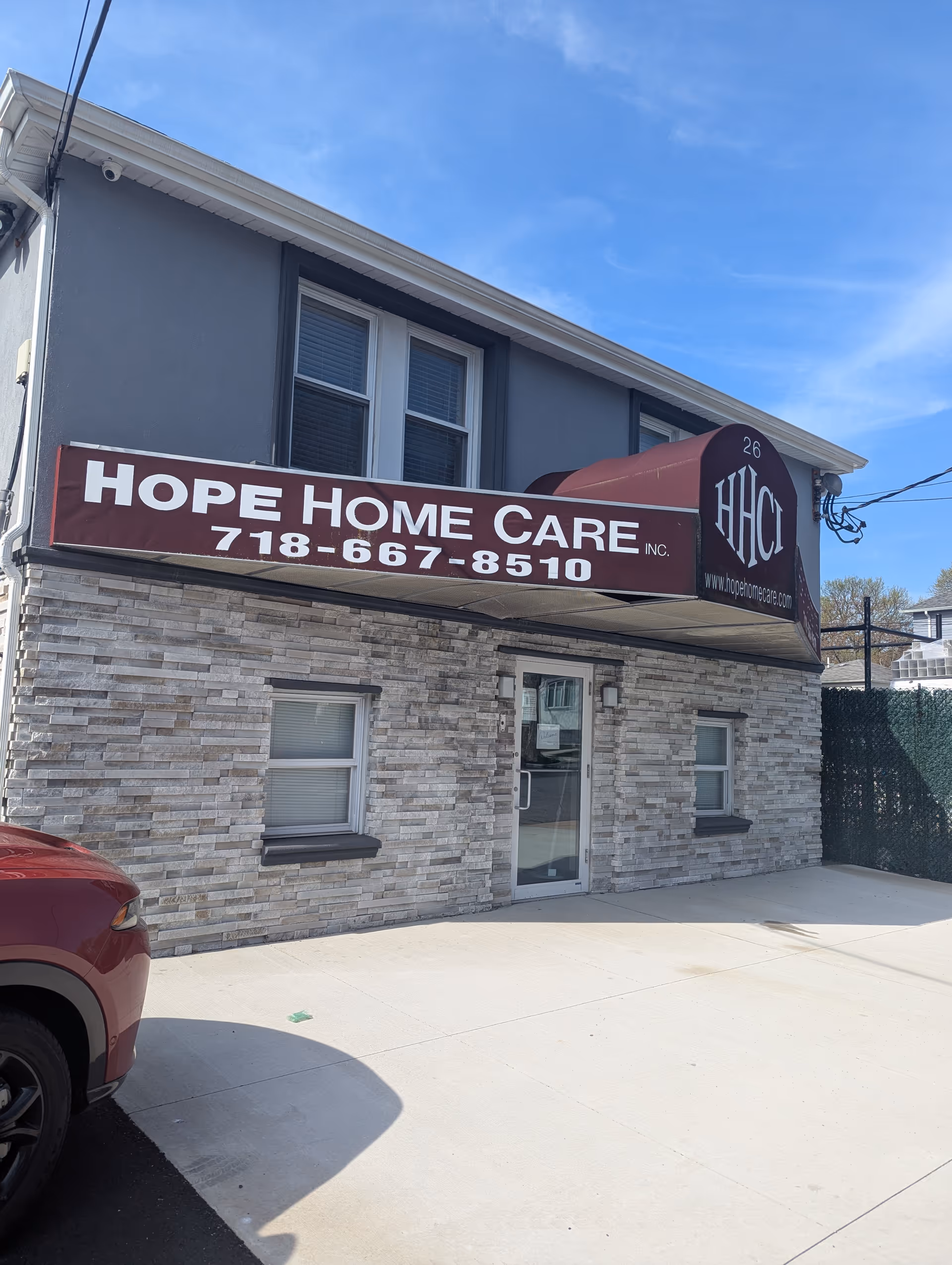 Two-story building with a maroon Hope Home Care sign over the entrance.