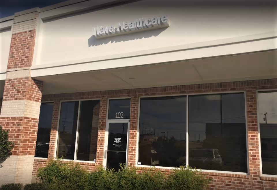 Exterior view of Wave Healthcare front entrance with brick facade and large windows