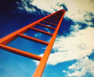 A red ladder extends toward a partly cloudy blue sky.