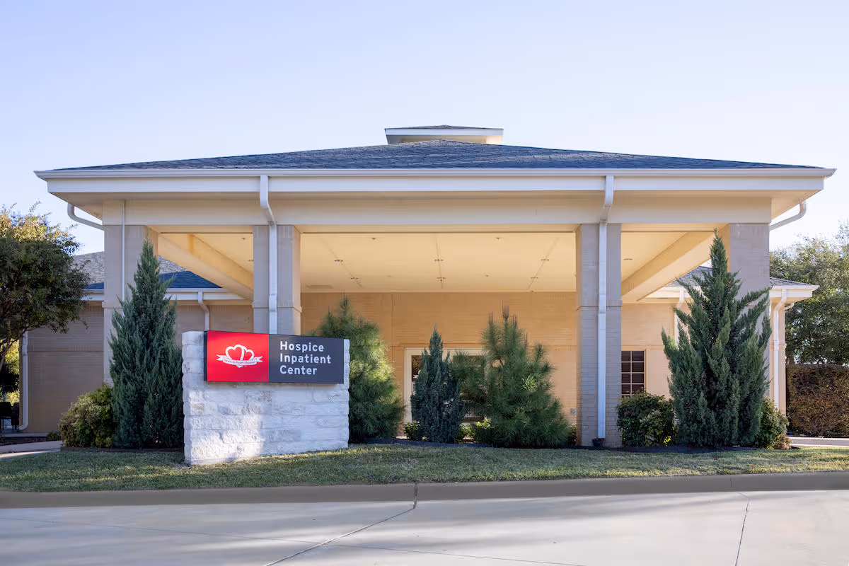 Heart to Heart Hospice House exterior with a covered entrance and landscaped front yard.