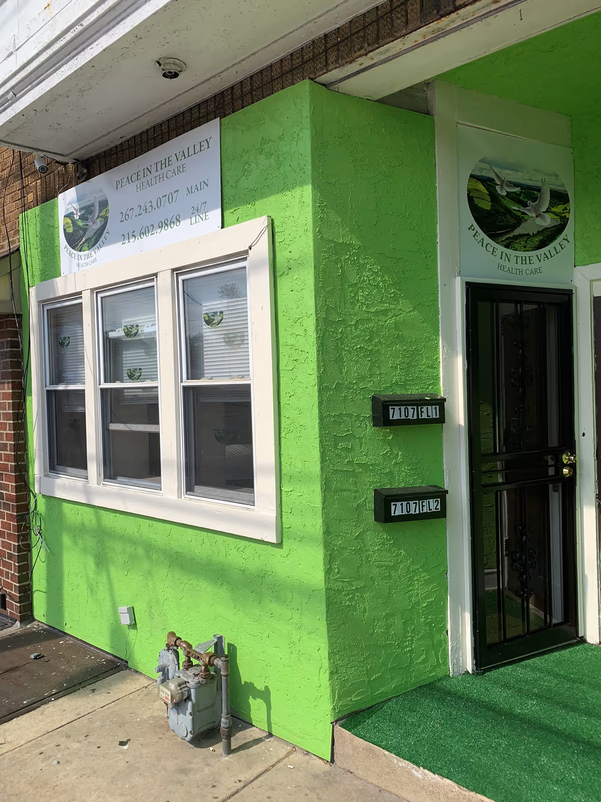 Bright green exterior wall and entrance of Peace in the Valley Health Care.