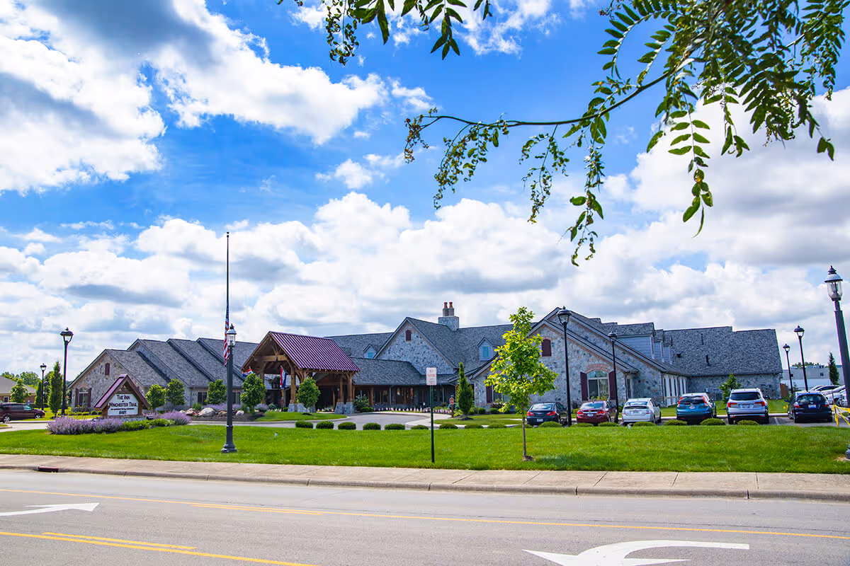 Exterior view of The Inn at Winchester Trail with front entrance and parking.