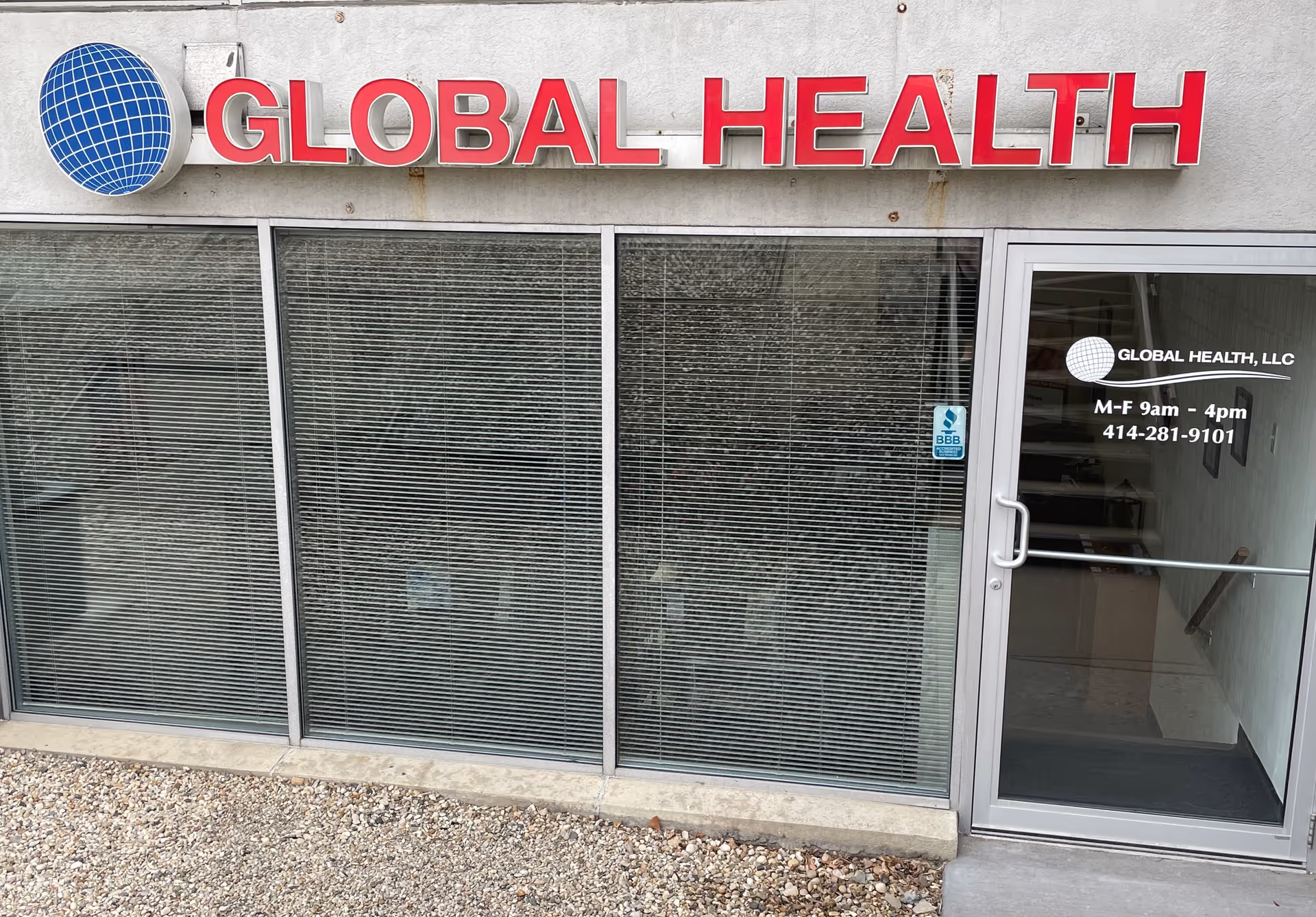 Front of Global Health LLC Prescription Mail Order facility with glass storefront and sign